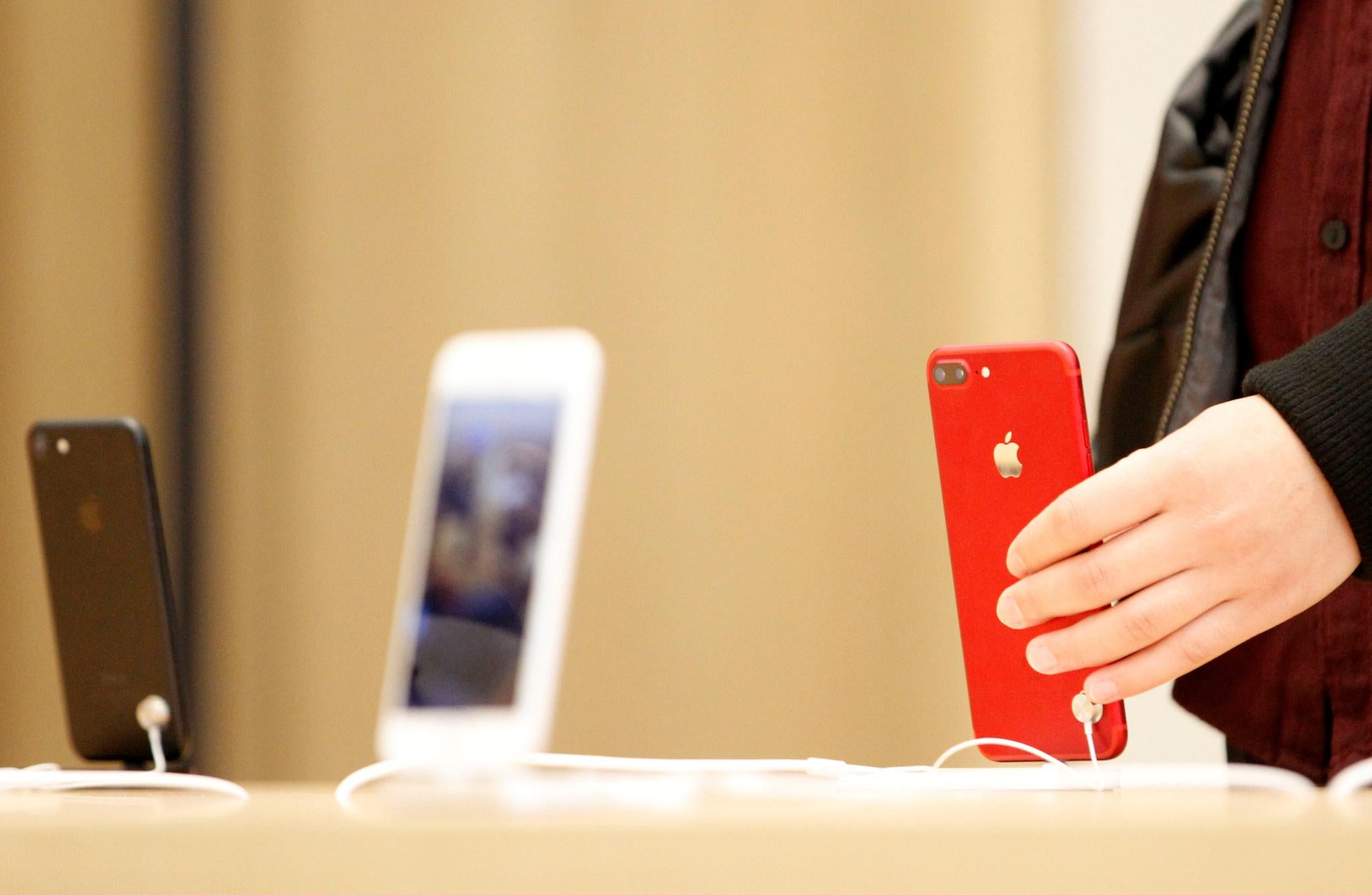 A person holds a red iPhone product at a Apple store in Nanjing, Jiangsu province, China, March 25, 2017. Picture taken March 25, 2017