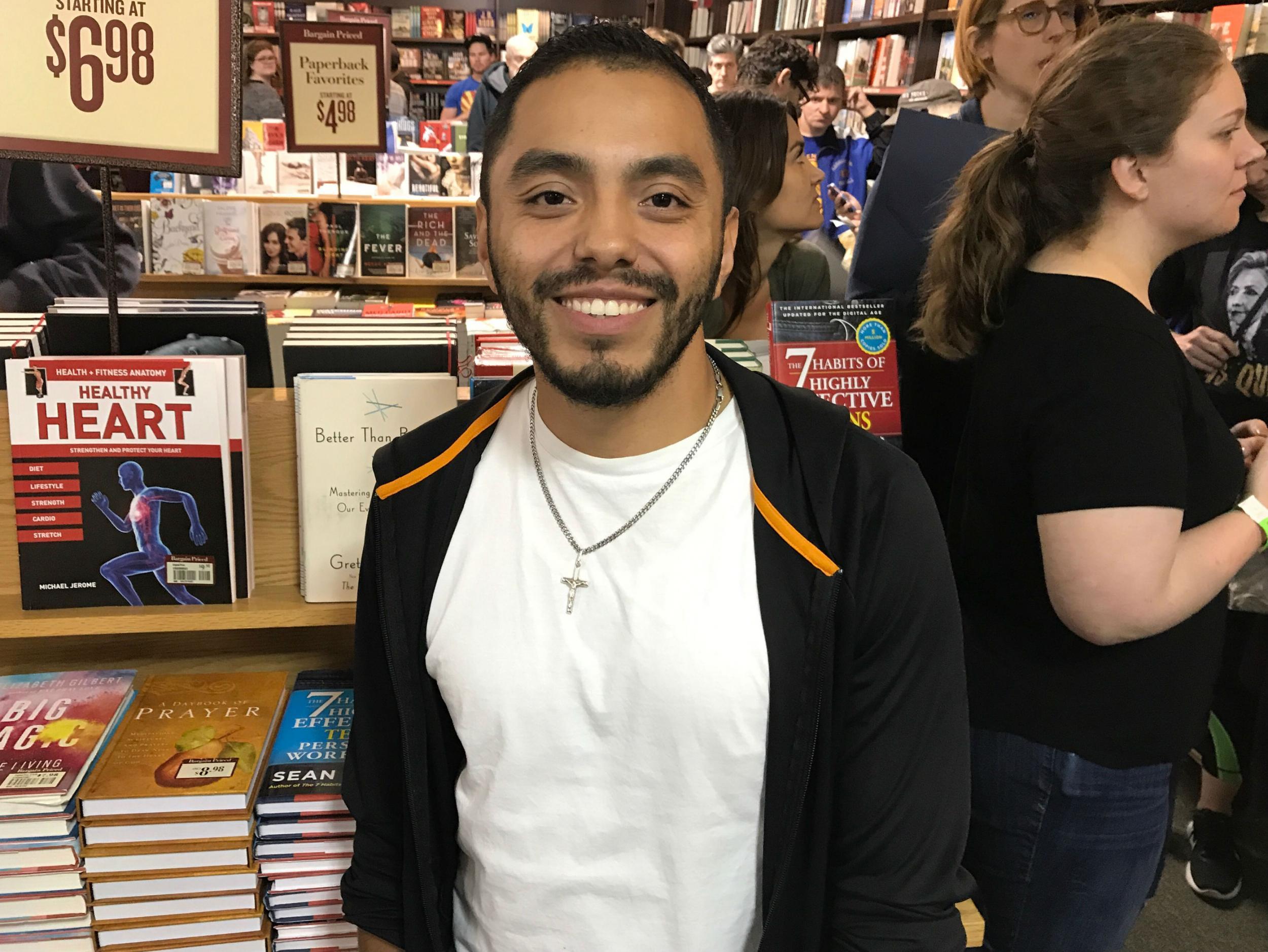 Juan Cuba smiles at the front of the line for Hillary Clinton's book signing