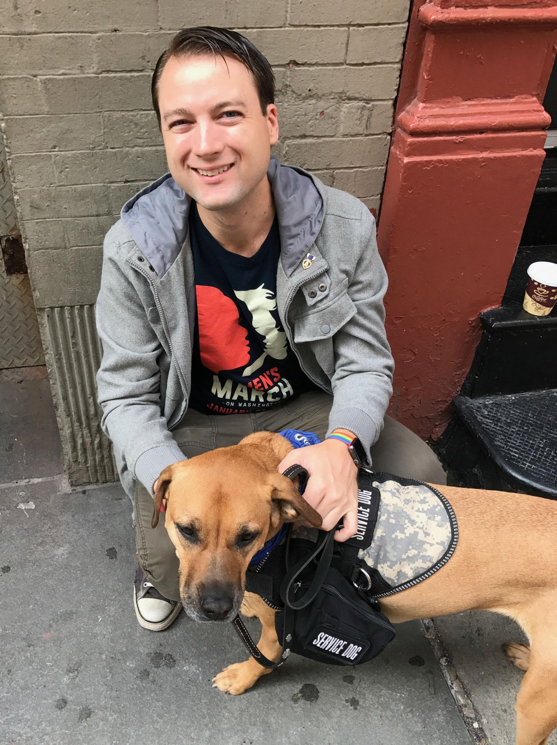 John Eubanks waits in line with his dog, Harley Quinn