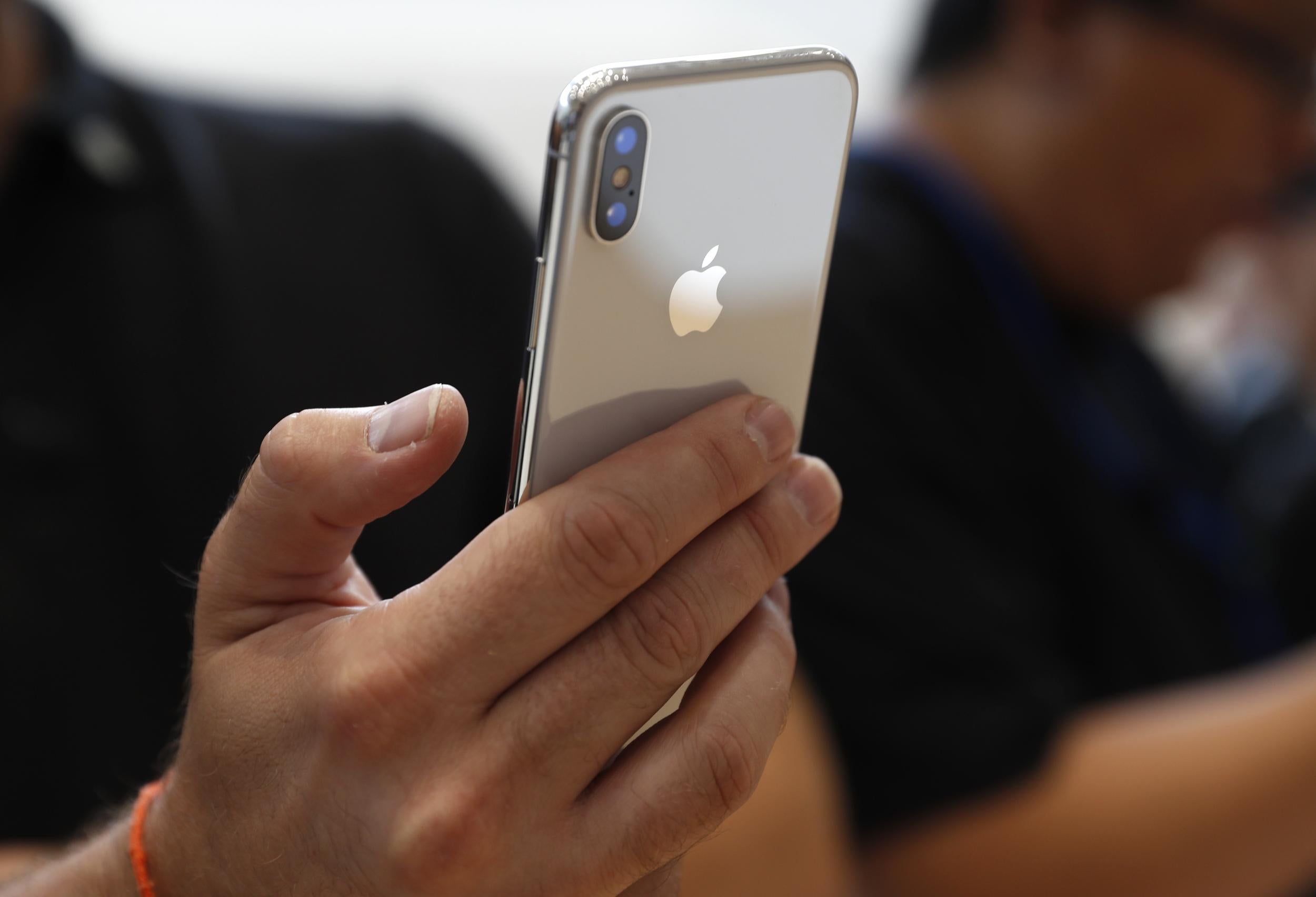 An attendee checks out a new iPhone X during an Apple launch event in Cupertino, California, U.S. September 12, 2017