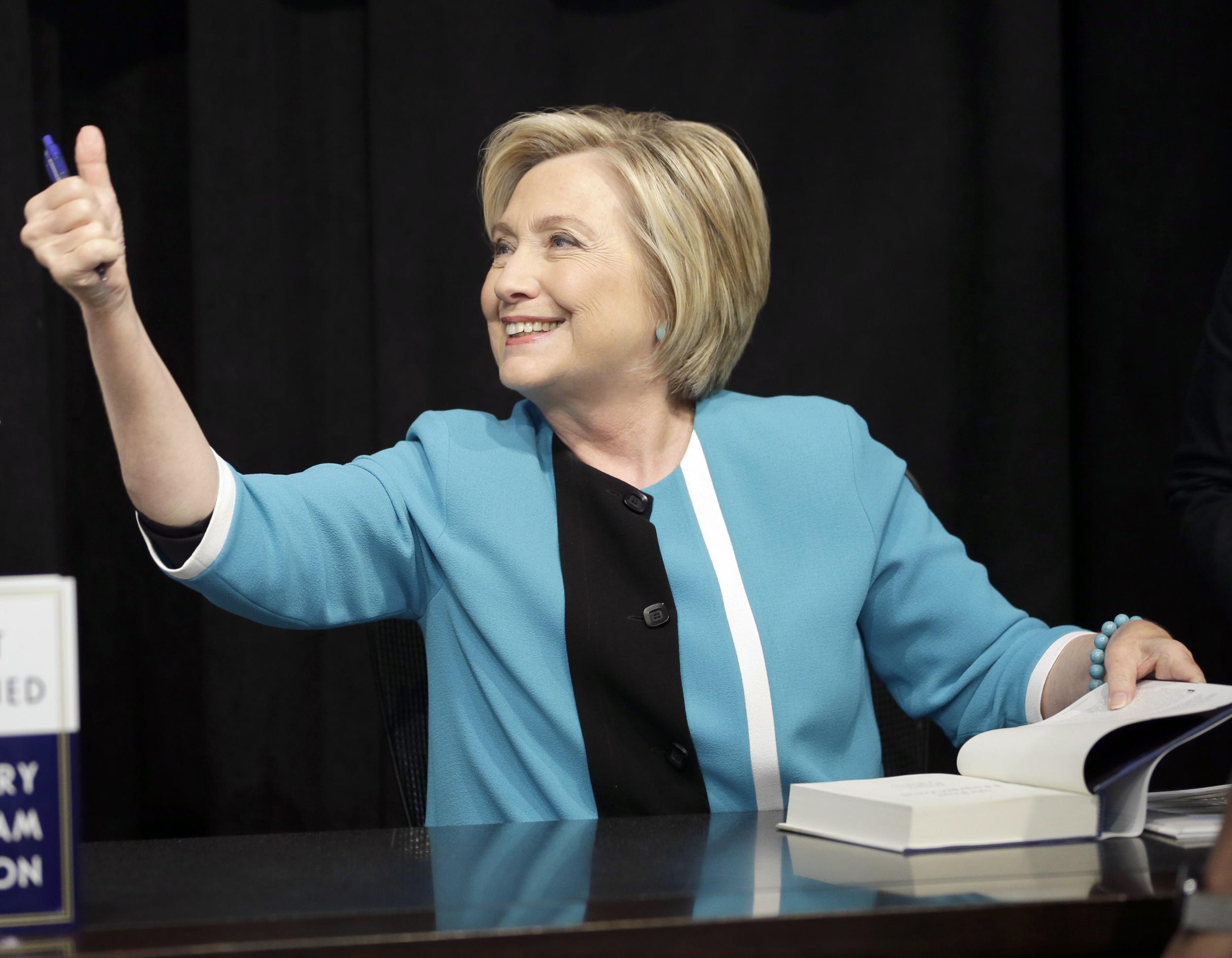 The former presidential candidate signs copies of her book at a New York store