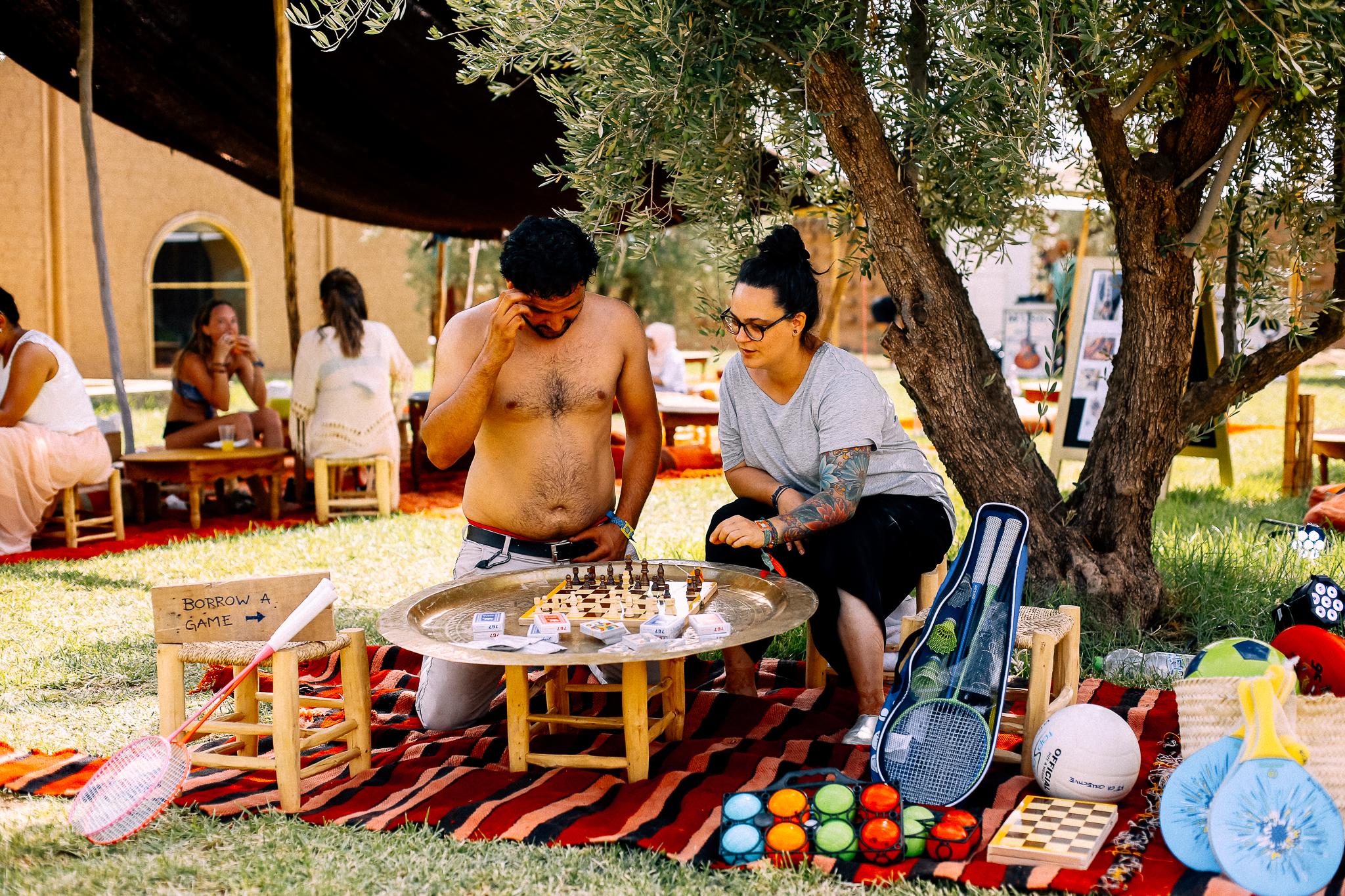 Playing games in the shade at Villa Janna, the mud-brick ecolodge that hosts the festival (Delicia Celik)