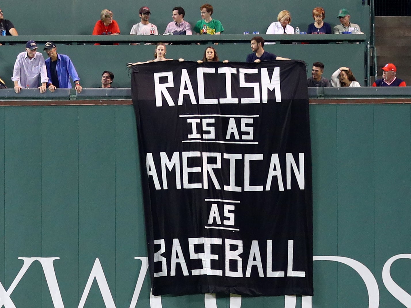 The individuals were escorted out of the stadium after revealing the banner