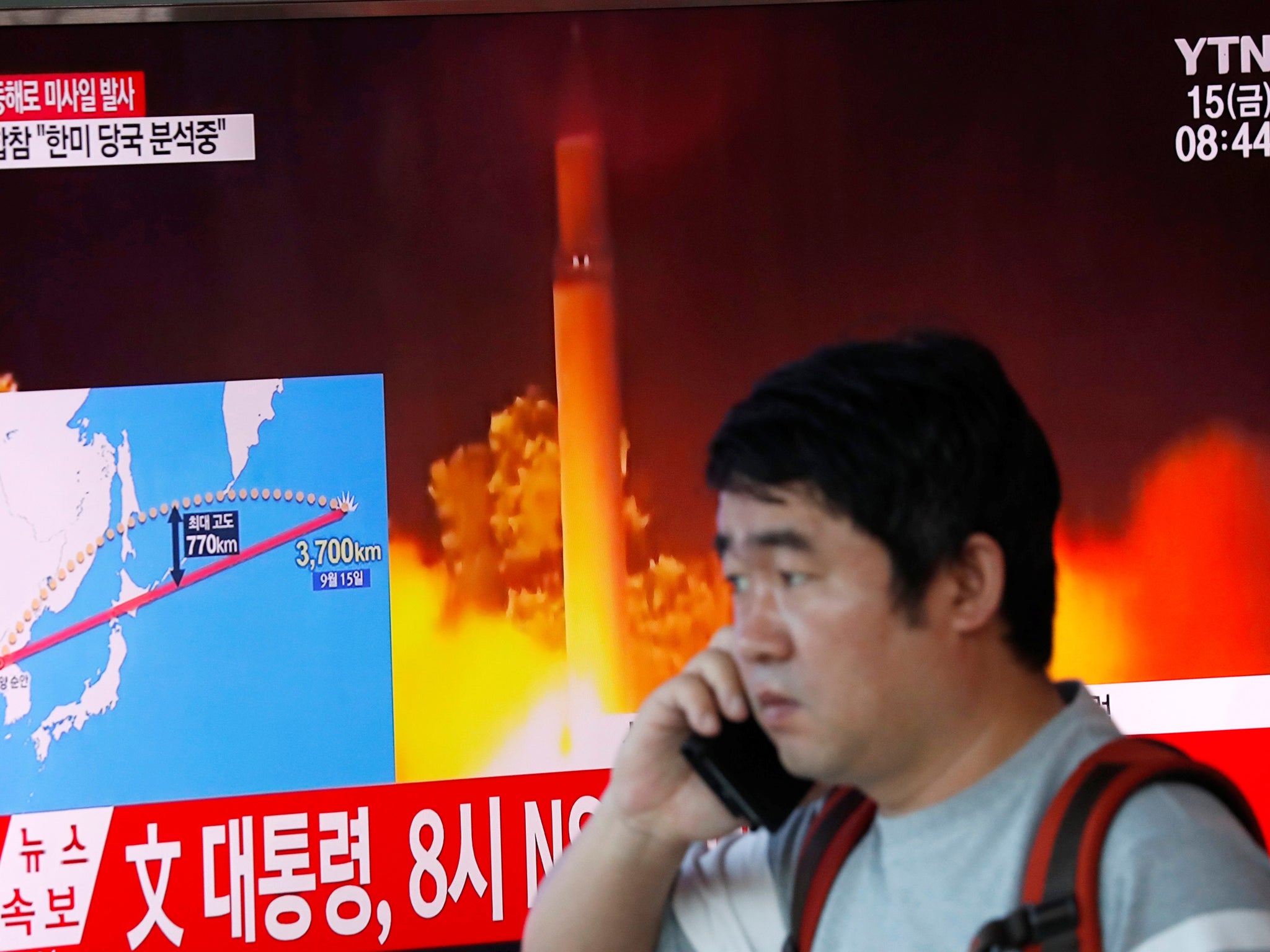 A television broadcasts a news report on North Korea firing a missile that flew over Japan's northern Hokkaido island