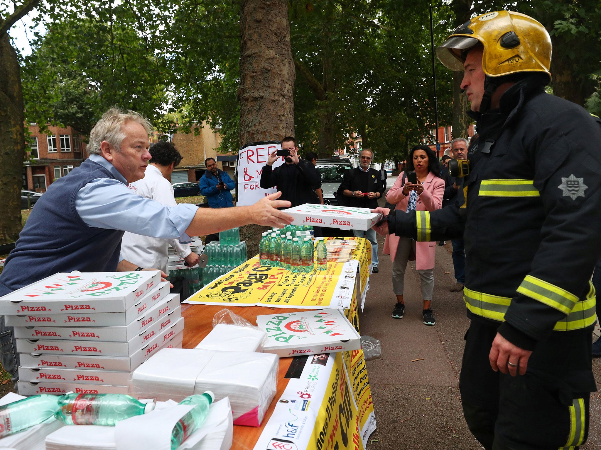 A local Italian restaurant hands out pizza and water to the emergency services