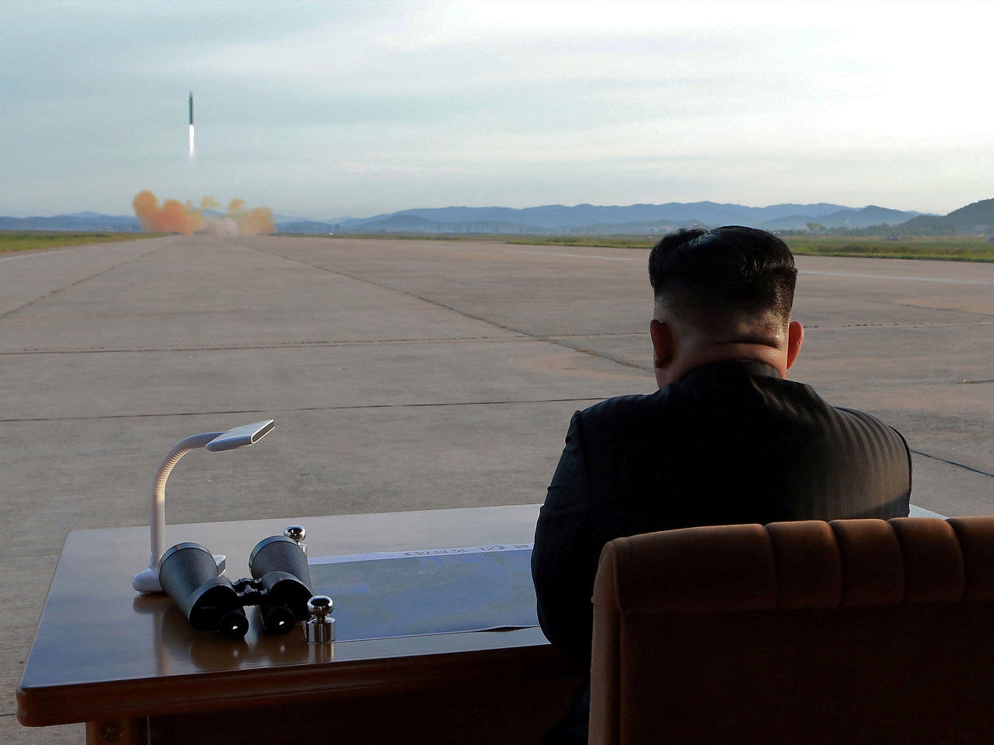 Kim Jong-un purportedly watches the launch of a Hwasong-12 missile in this undated photo released by North Korea’s news agency