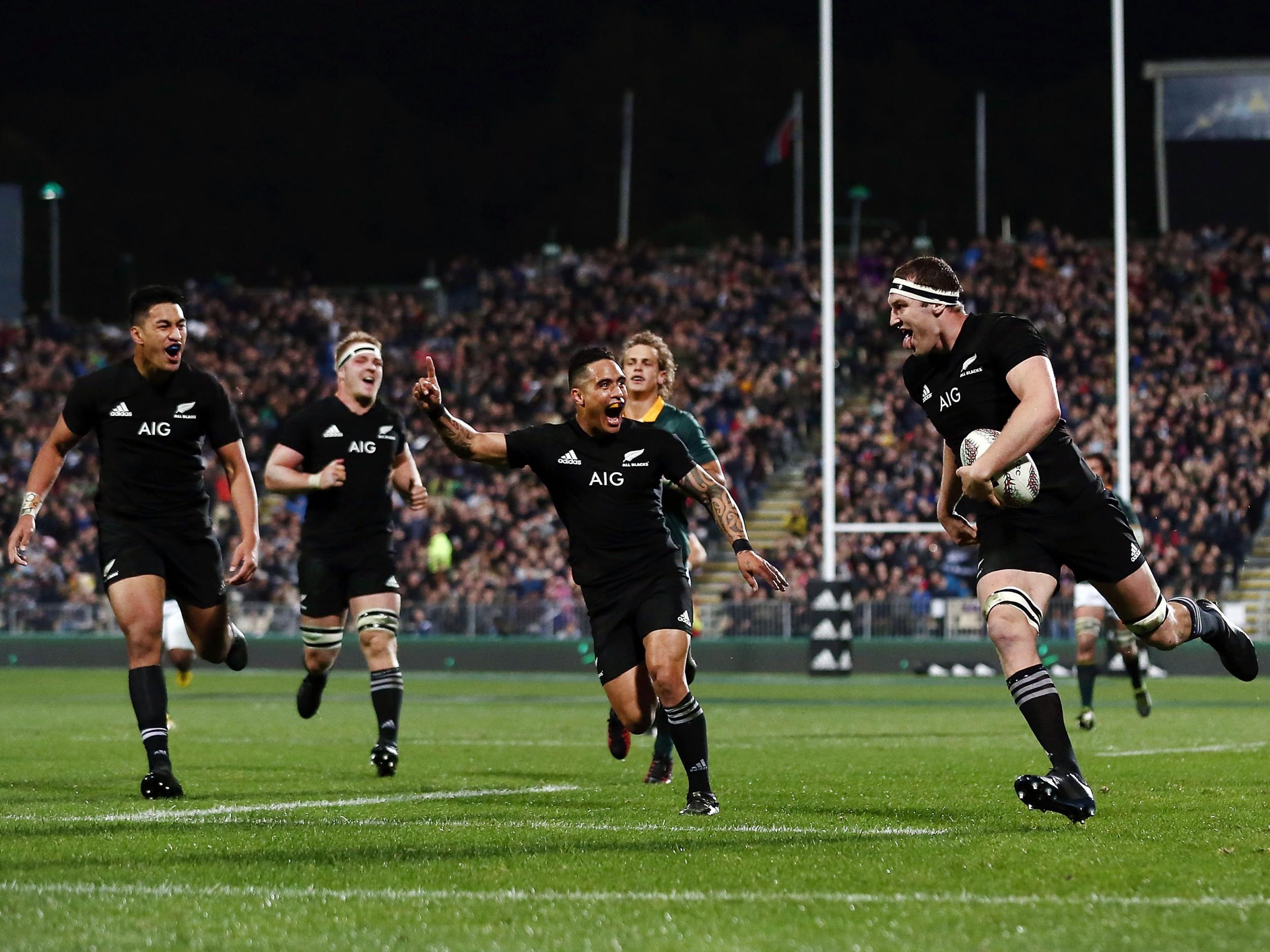 All Blacks players celebrate as Brodie Retallick scores one of eight tries