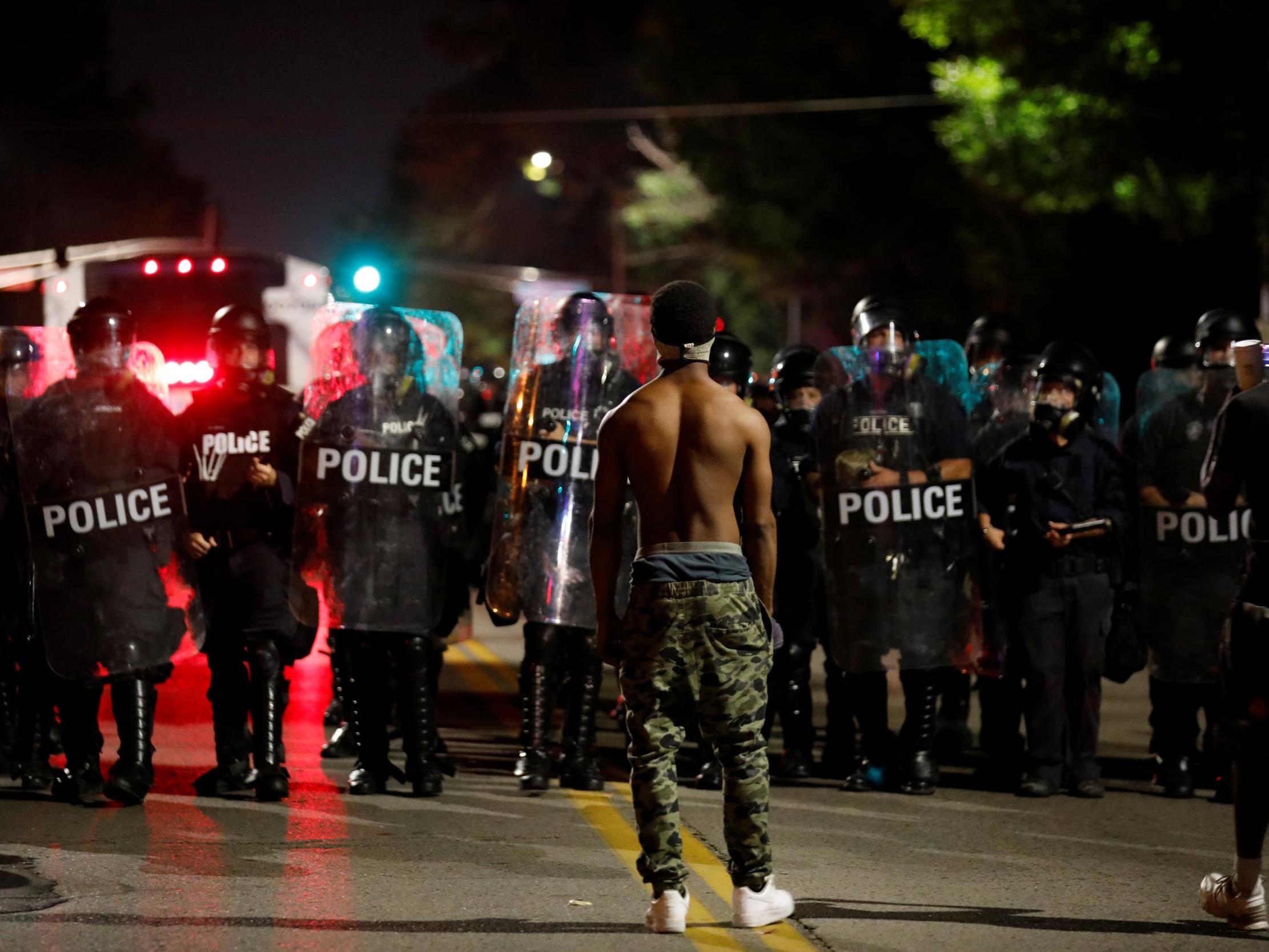 A protester facing police during the demonstration