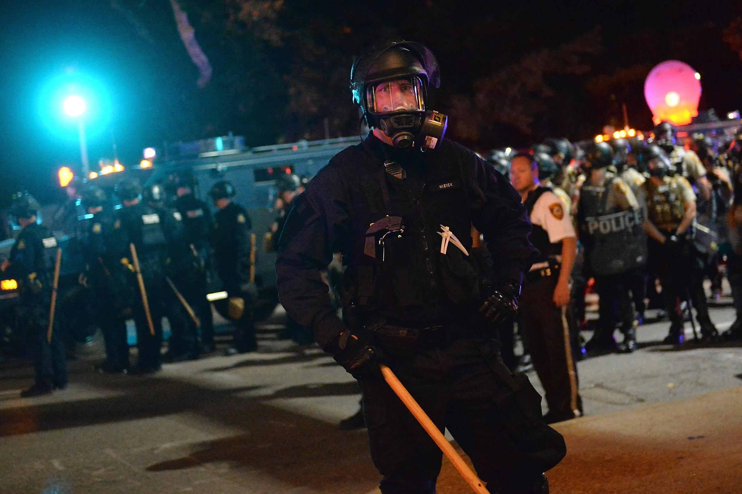 Law enforcement officers stand guard during a protest action following a not guilty verdict