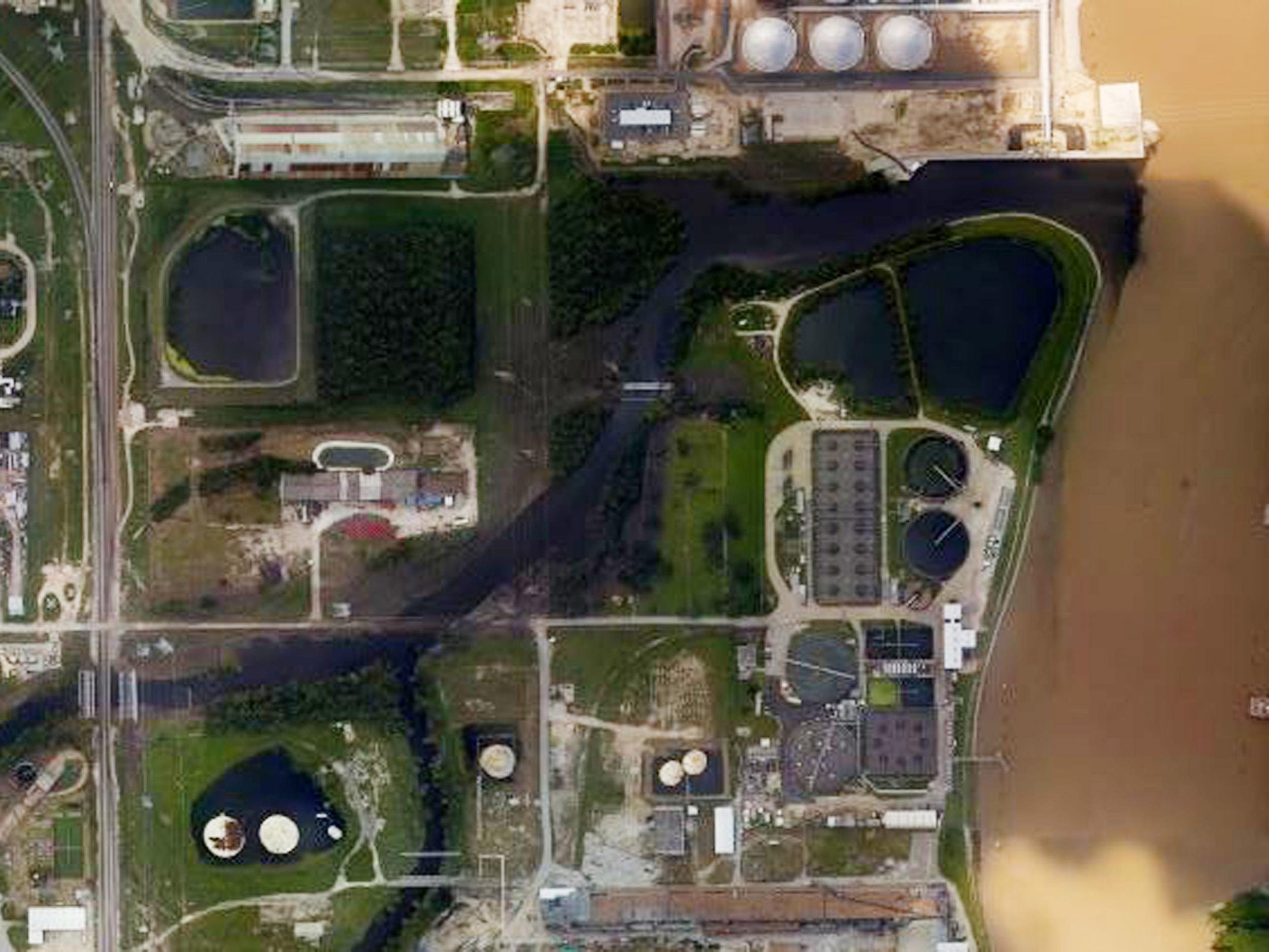 An aerial photo shows floodwaters surrounding the US Oil Recovery Superfund site outside Houston flowing into the San Jacinto River