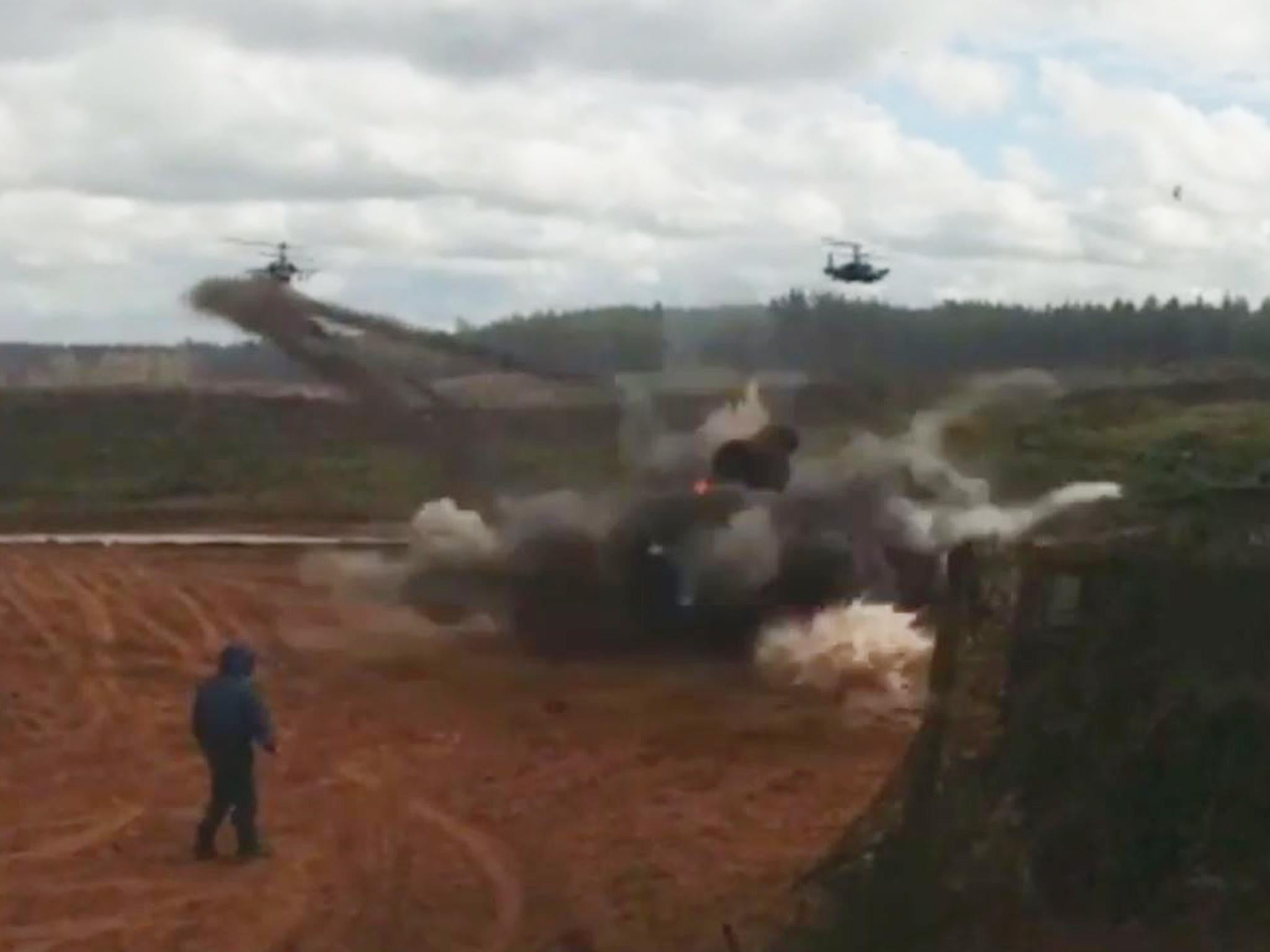 Part of a video allegedly showing rockets fired by a Russian military helicopter landing near a group of people observing the Zapad-2017 war games