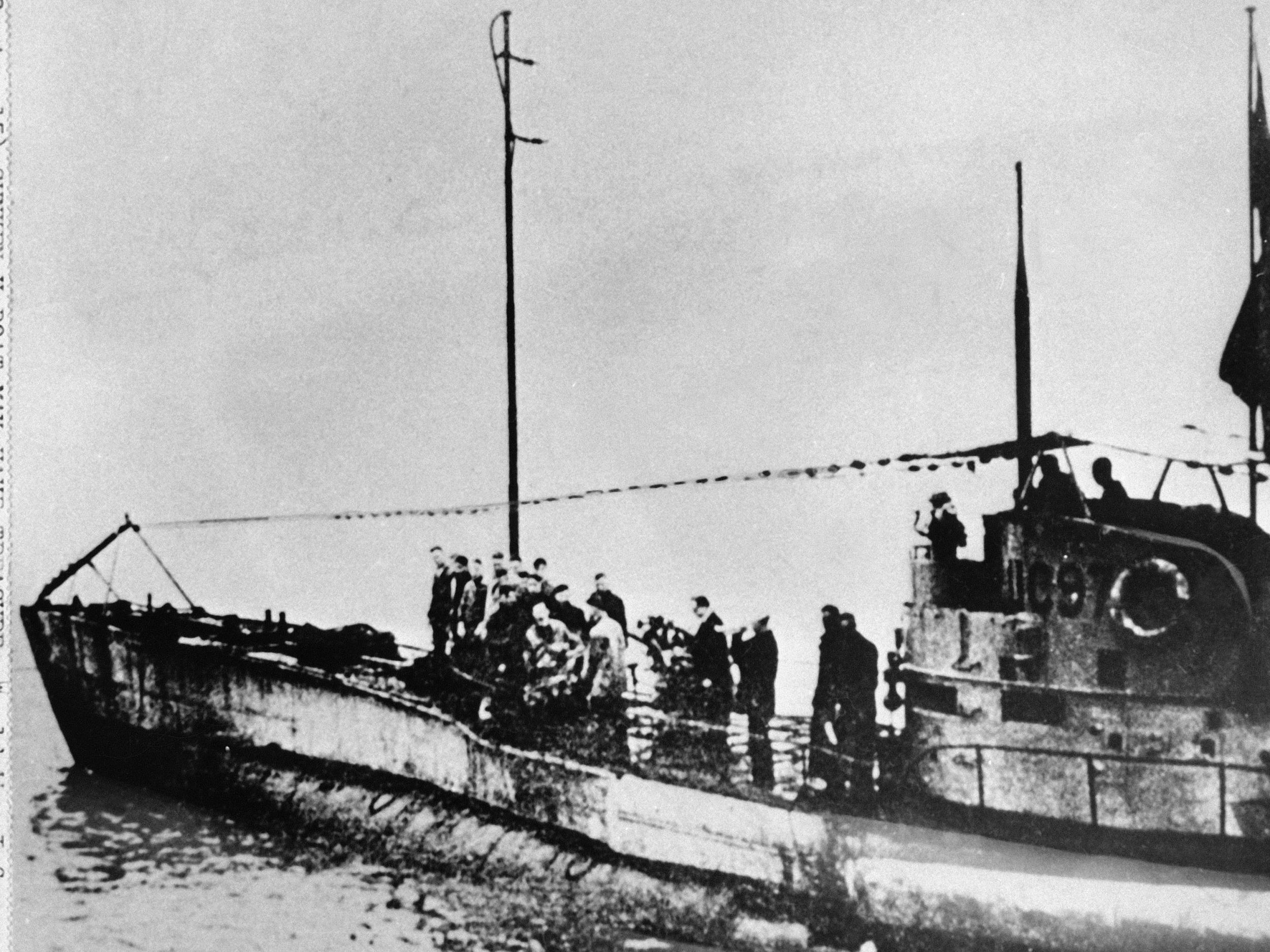 People stand on the deck of a World War I German submarine type UC-97