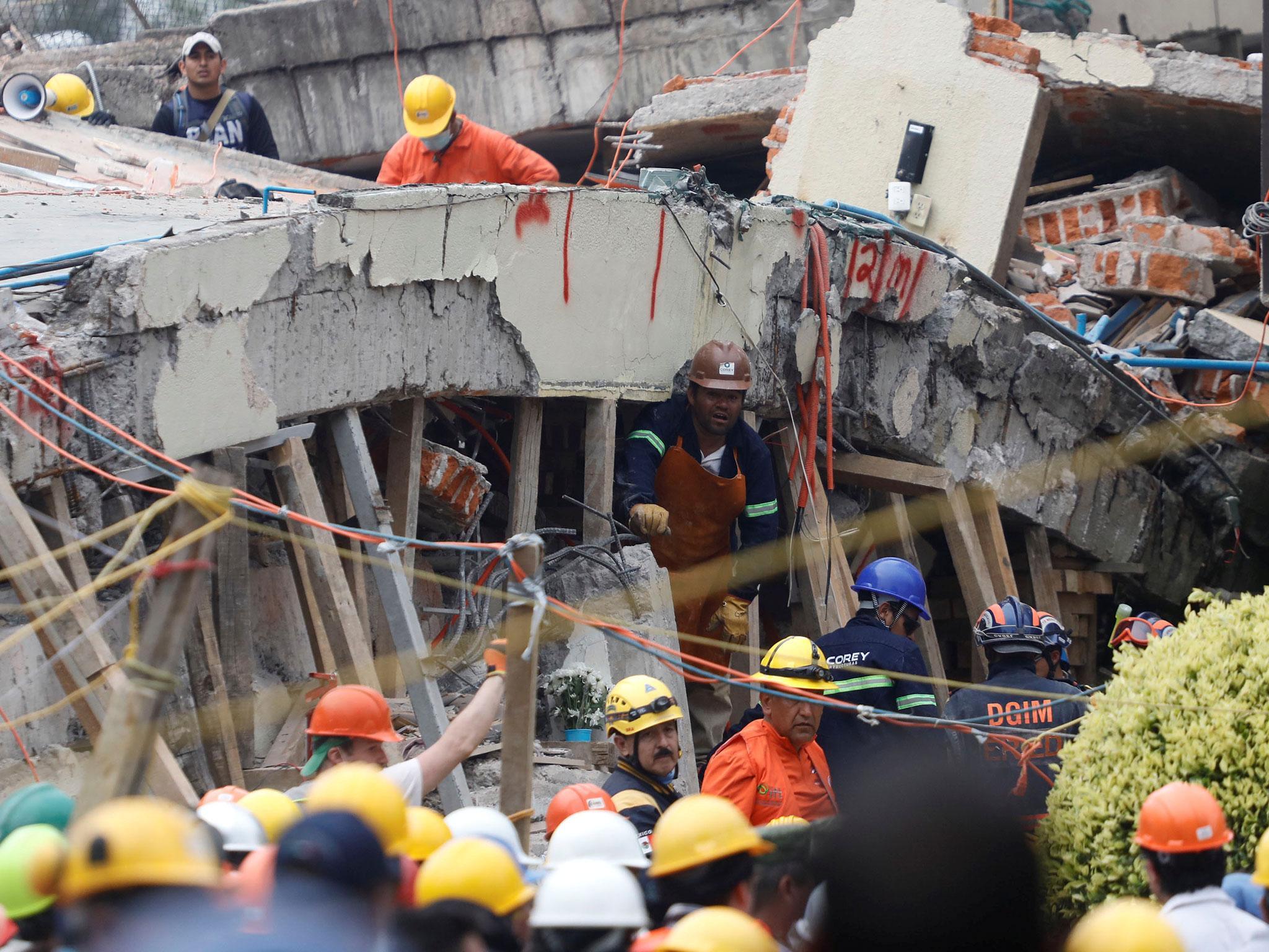 Rescue workers search through the rubble for students at Enrique Rebsamen school