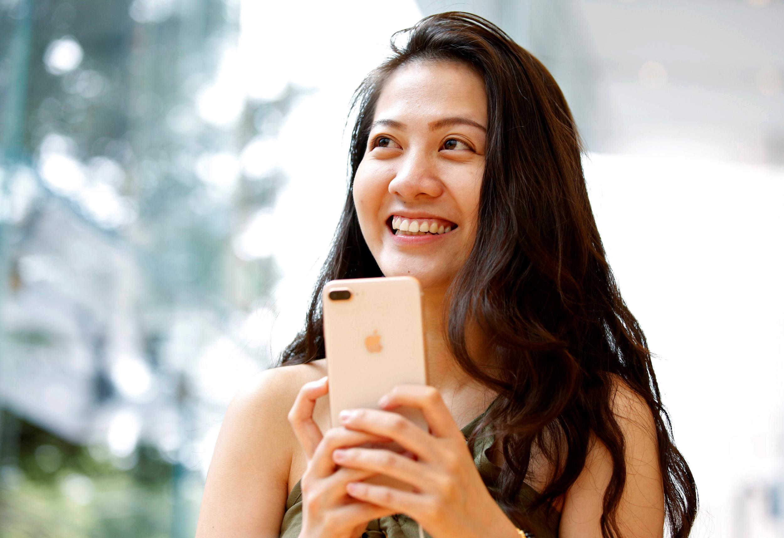 A woman holds Apple's new iPhone 8 Plus after it went on sale at the Apple Store in Tokyo's Omotesando shopping district, Japan, September 22, 2017