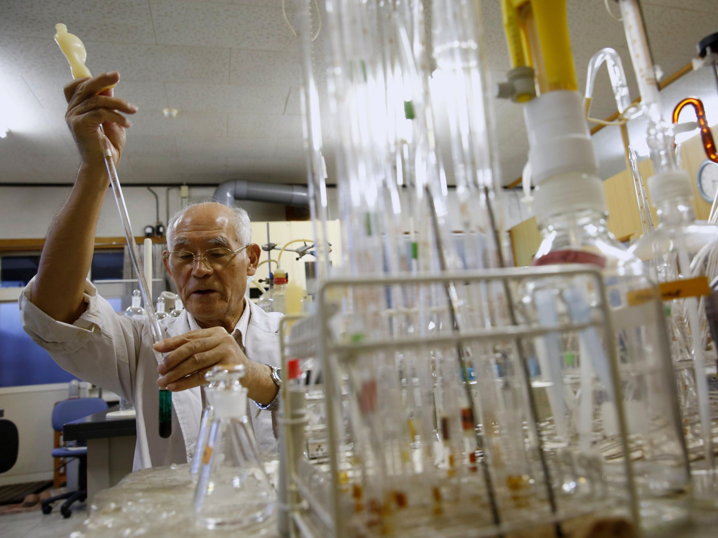 Hirokatsu Akagi, director of Minamata's International Mercury Laboratory, demonstrates his method of measuring mercury content in biological materials at his lab