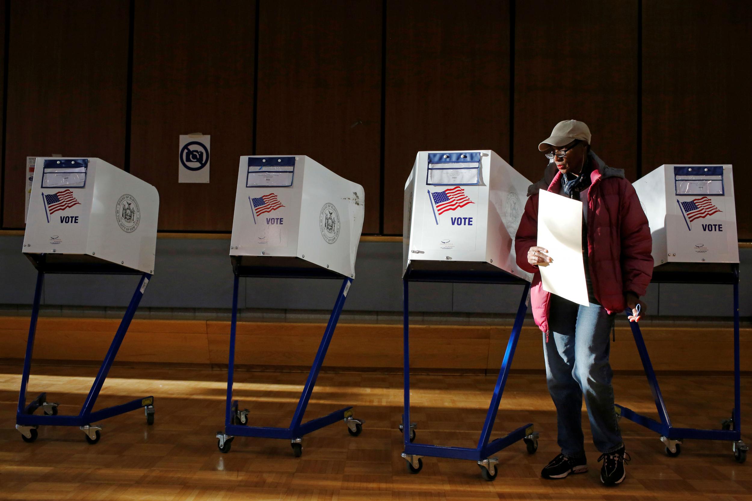 A woman exits the voting booth in the East Harlem neighbourhood of Manhattan, New York City, U.S. November 8, 2016.