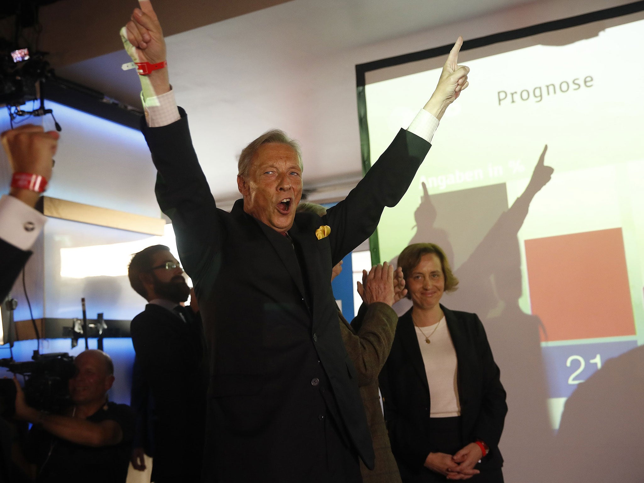 Armin-Paul Hampel of the anti-immigration party Alternative fuer Deutschland (AfD) reacts on first exit polls in the German general election