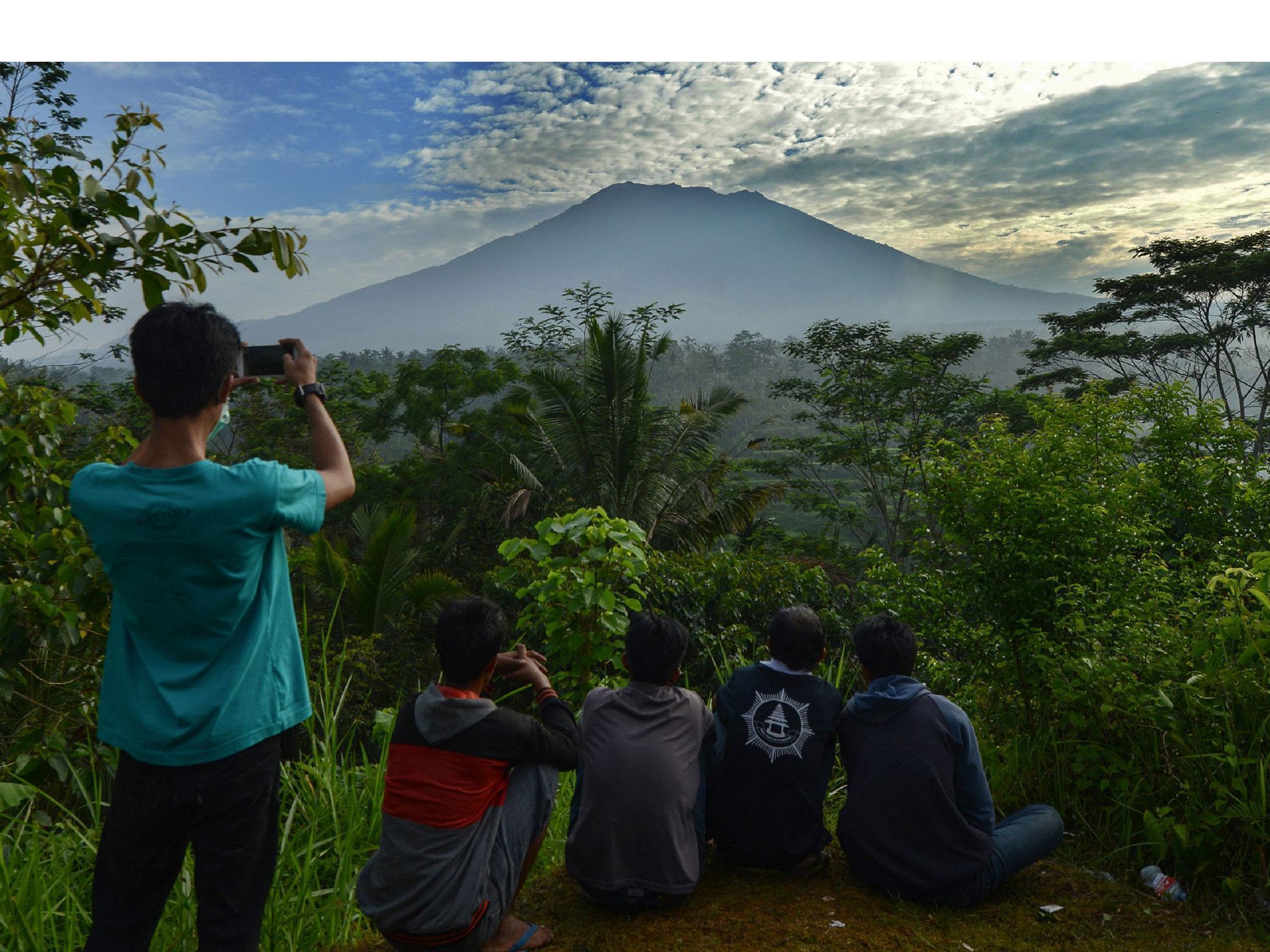 People look at Mount Agung in Karangasem on the Indonesian resort island of Bali