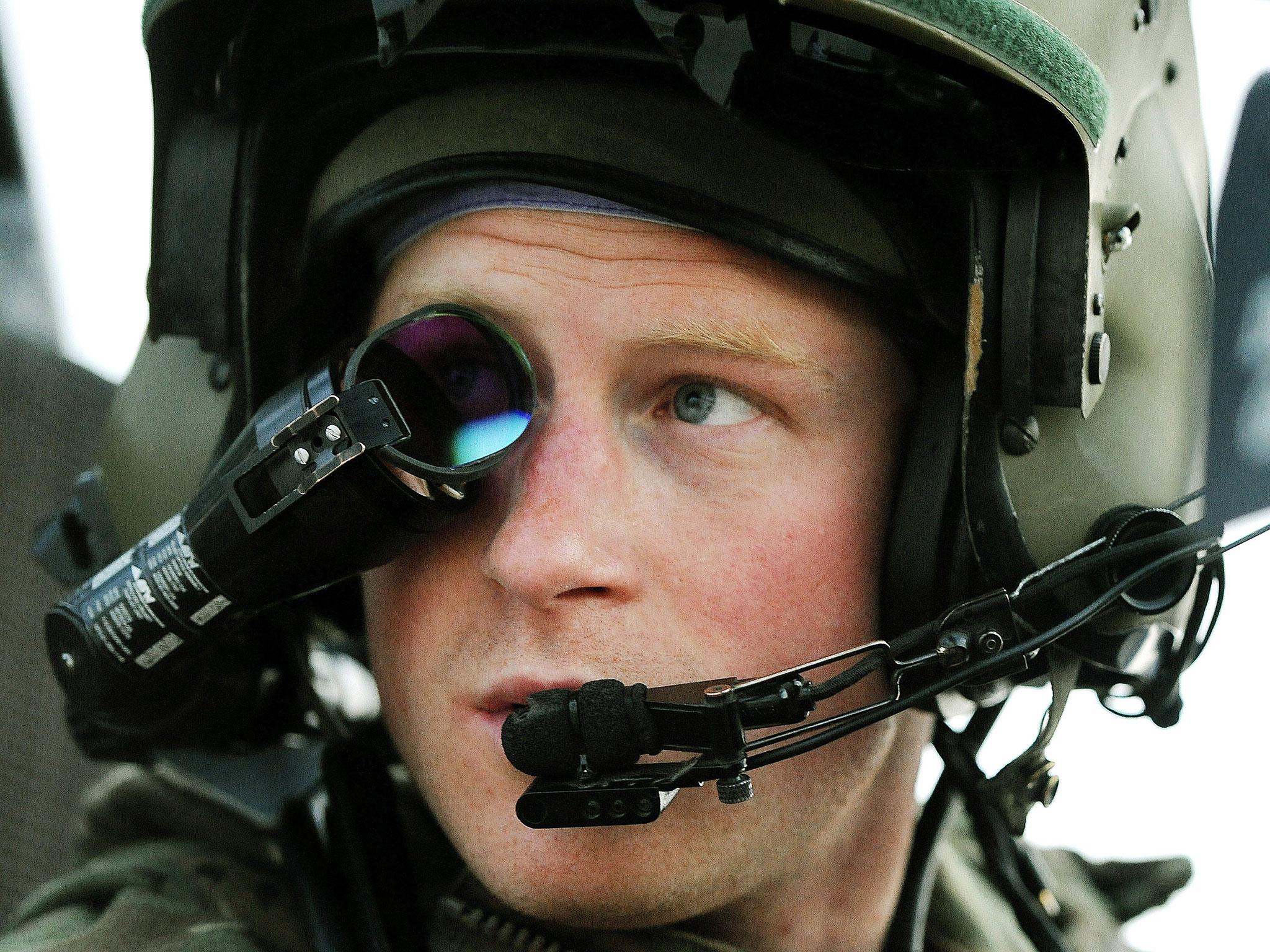 Prince Harry wears his monocle gun sight as he sits in the front seat of his Apache helicopter