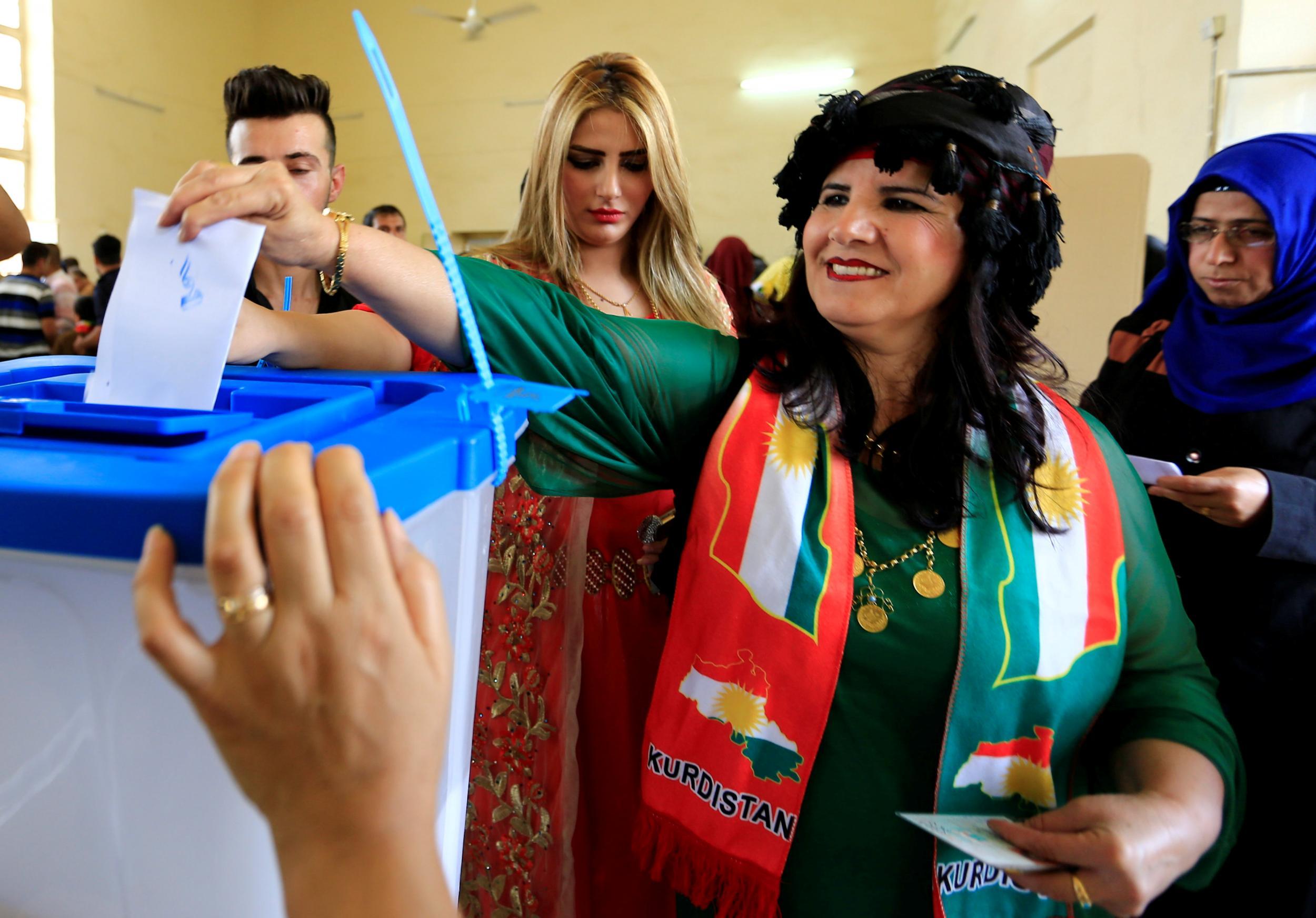 A woman casts her vote in the Kurdish independence referendum in Kirkuk, northern Iraq, on 25 September 2017