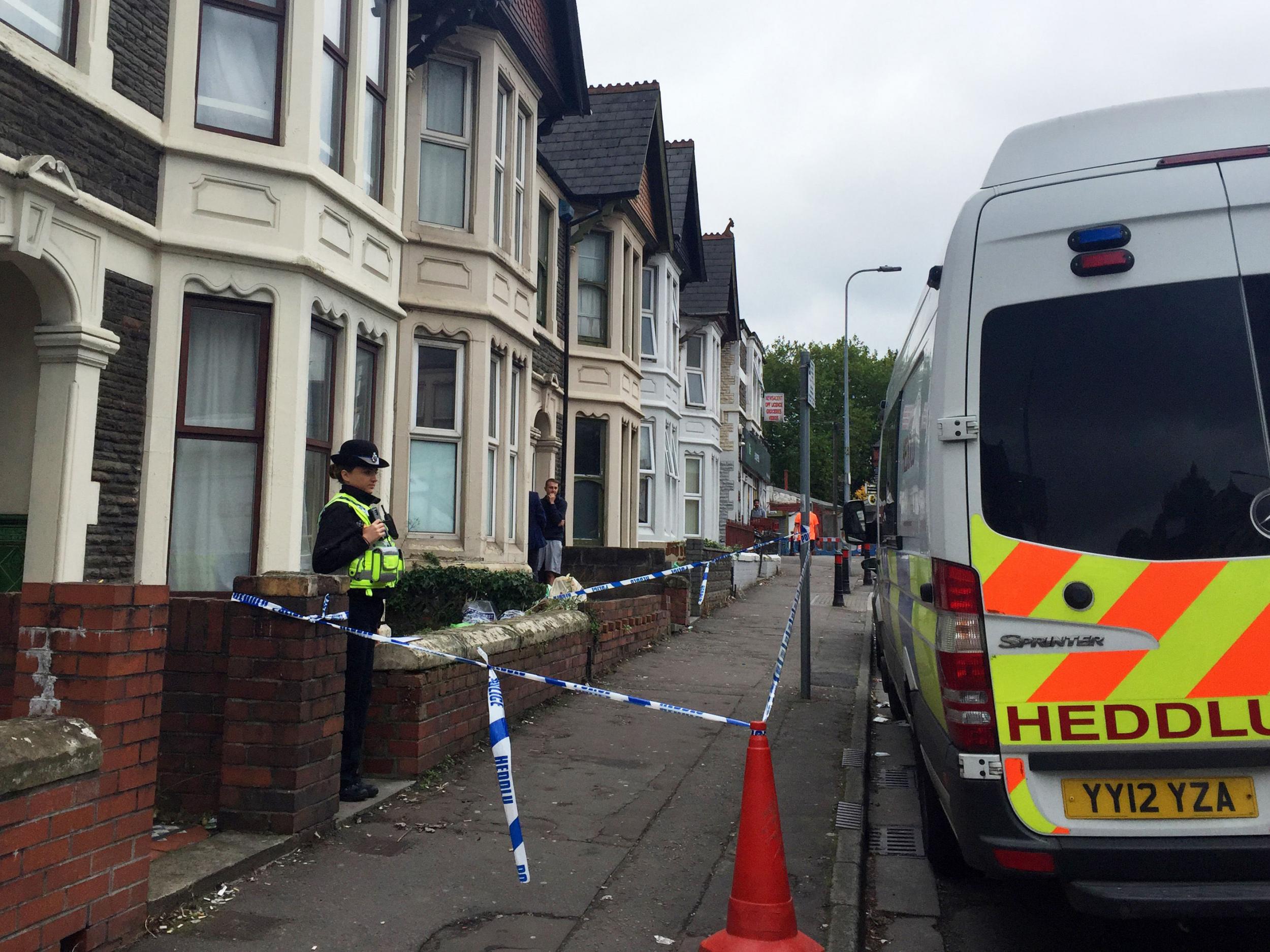 A police officer stands outside a property in Pen-y-Wain Road, Roath, Cardiff