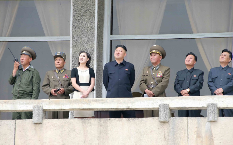 Mr Kim and Ms Ri look on during a visit to Unit 1017 of the Korean People's Army (KPA) Air and Anti-Air Force (Reuters)