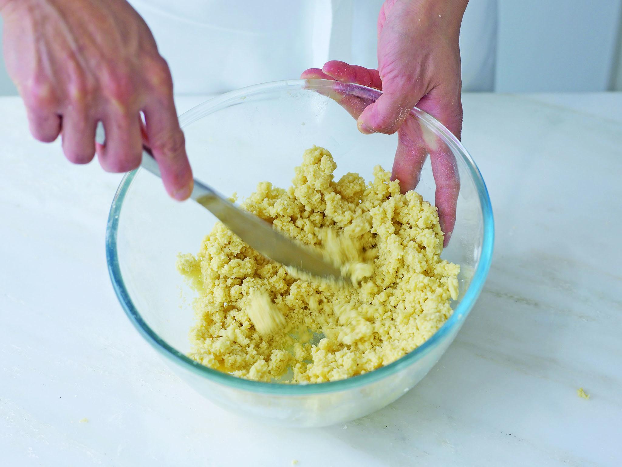 6. Pull some of the flakes to the side and feel them; if they are very dry, add a little more of the liquid to any dry areas of crumb and use the knife again. Don’t be tempted to add too much liquid, as it can make the pastry tough. Once you think the flakes will come together, stop adding liquid