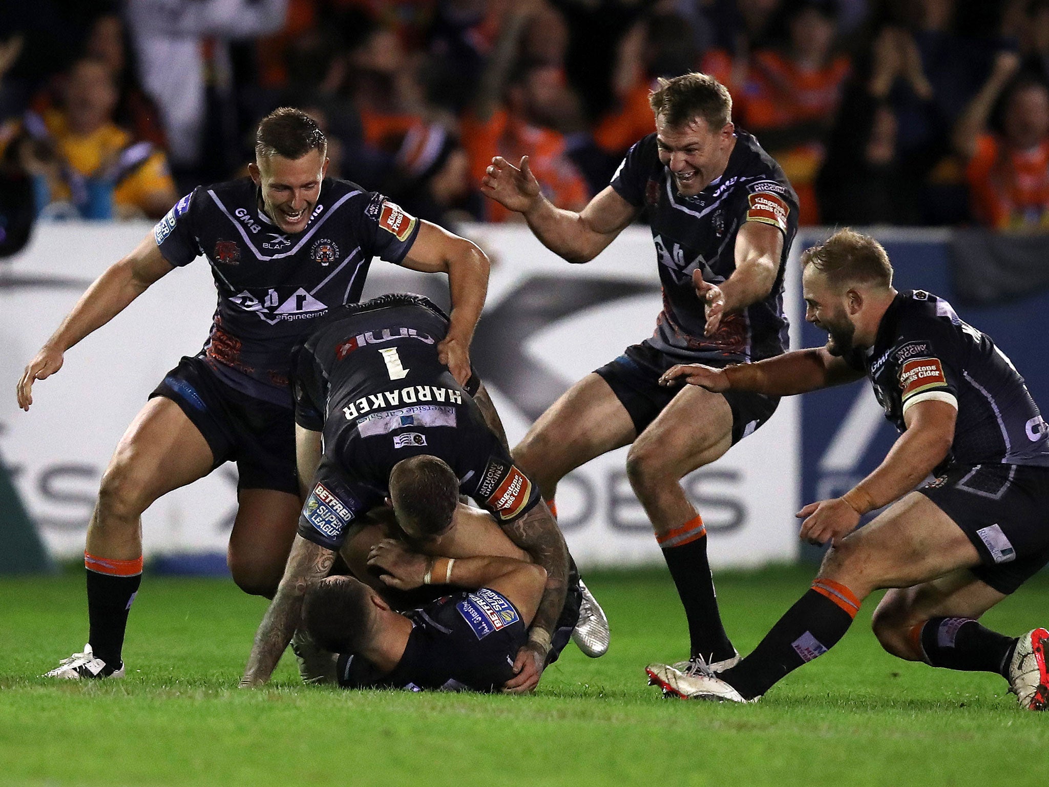 Luke Gale celebrates with teammates after kicking the winning golden point drop goal