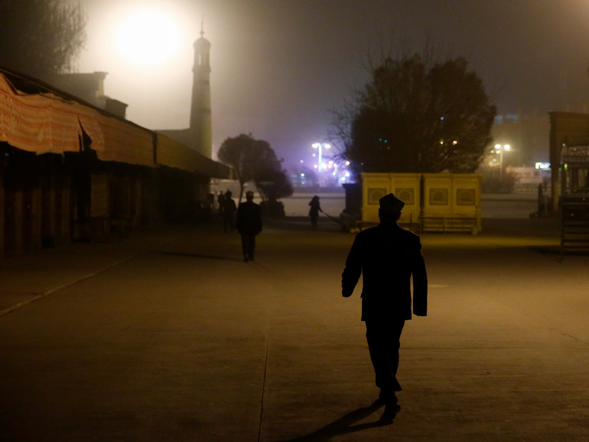 Men walk to the Id Kah Mosque for morning prayers in Kashgar, Xinjiang Uighur Autonomous Region, China, in March 2017