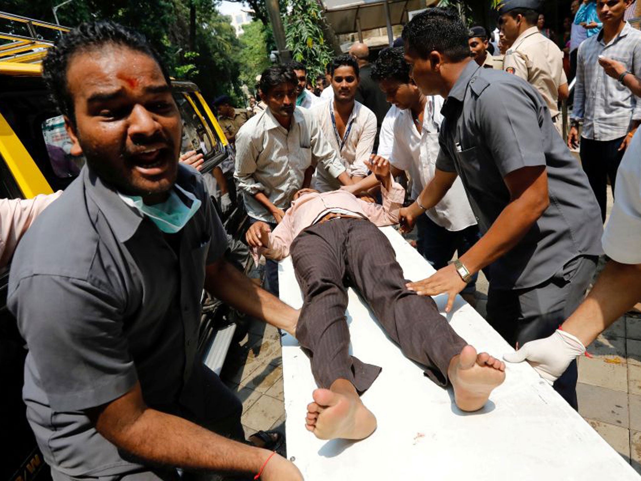 A man injured during the footbridge stampede is taken to hospital