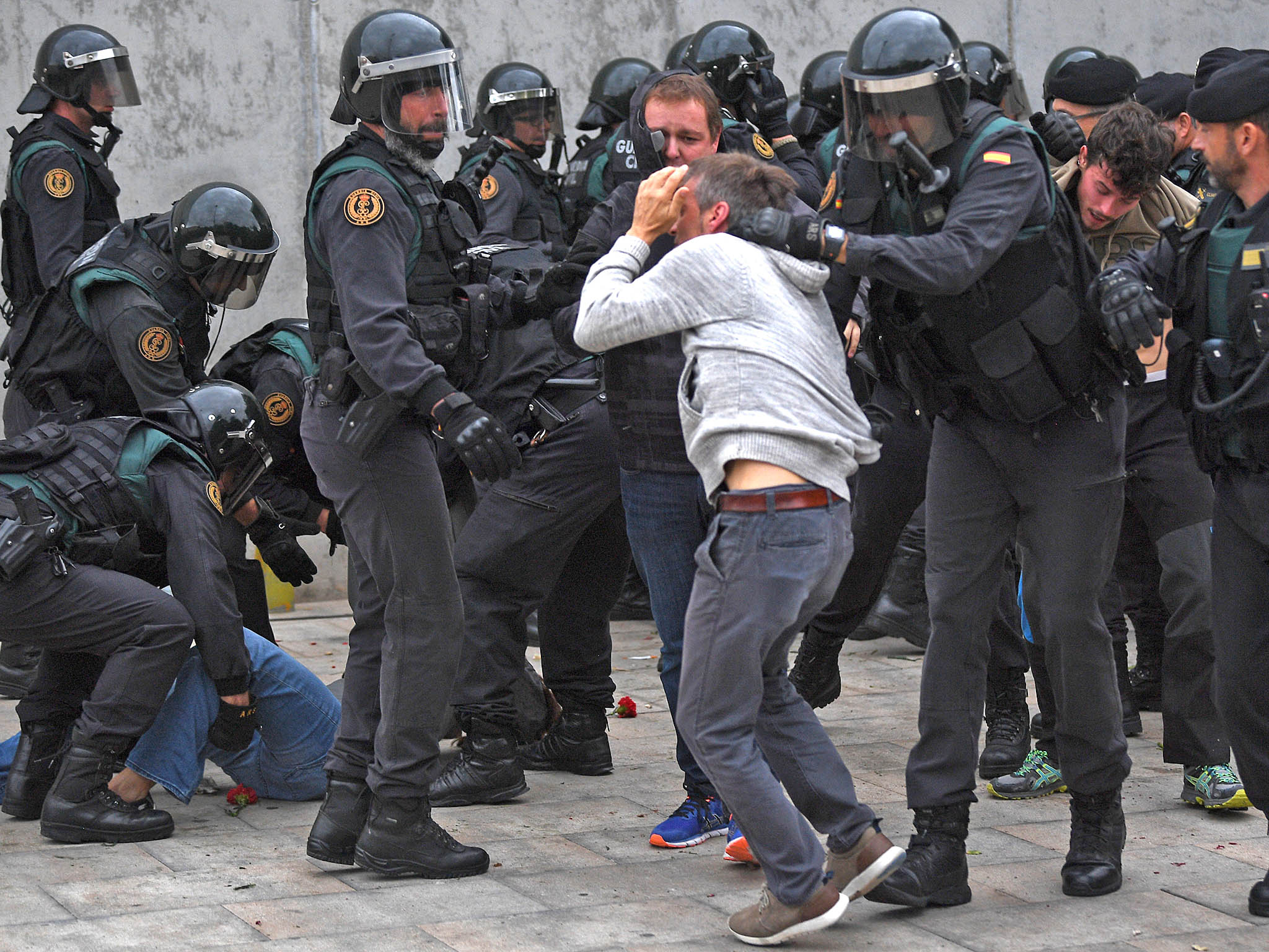 (Getty Images) Riot police clash with voters at polling stations across Catalonia