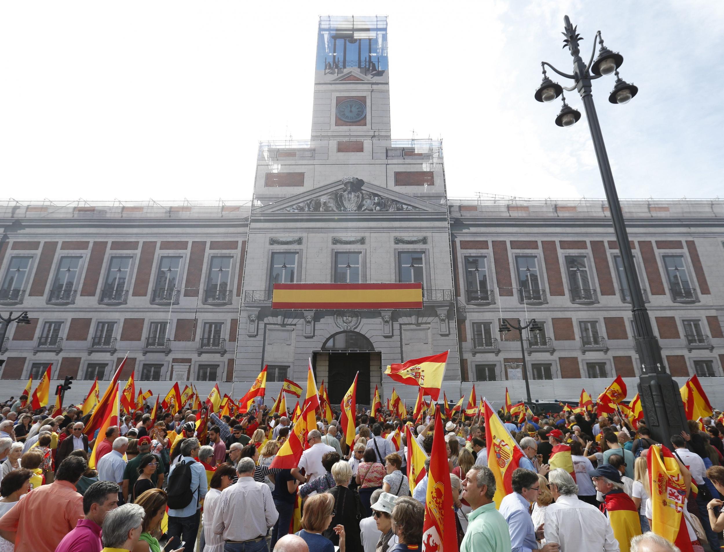 People wave Spanish national flags during a protest against the Catalan independence referendum