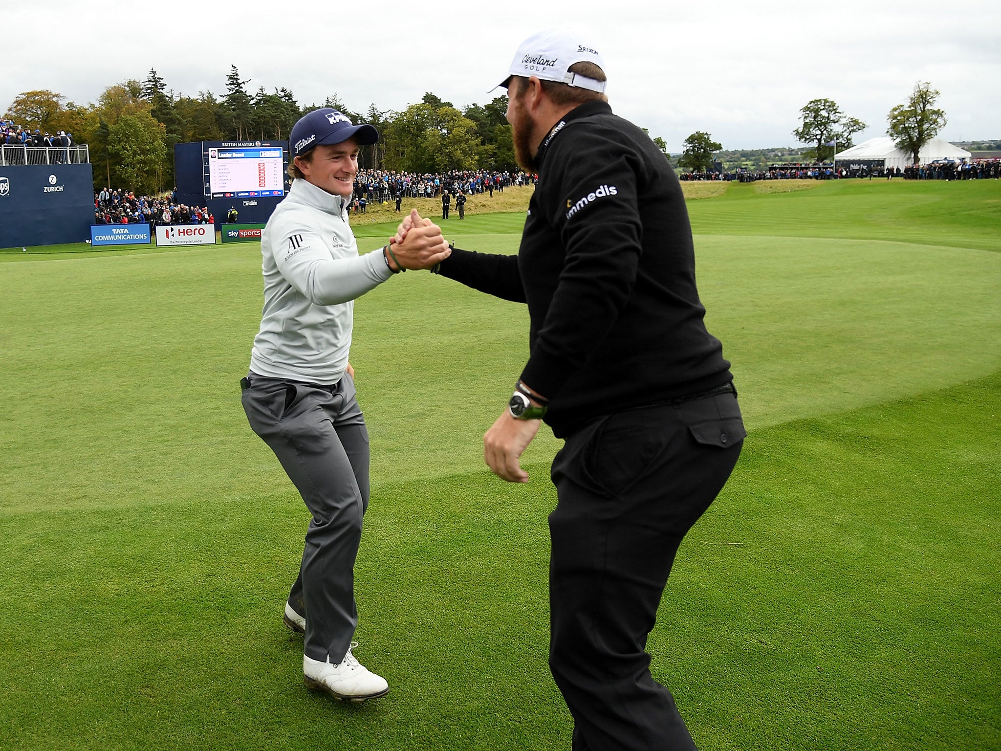 Shane Lowry congratulates Paul Dunne after securing victory at the British Masters