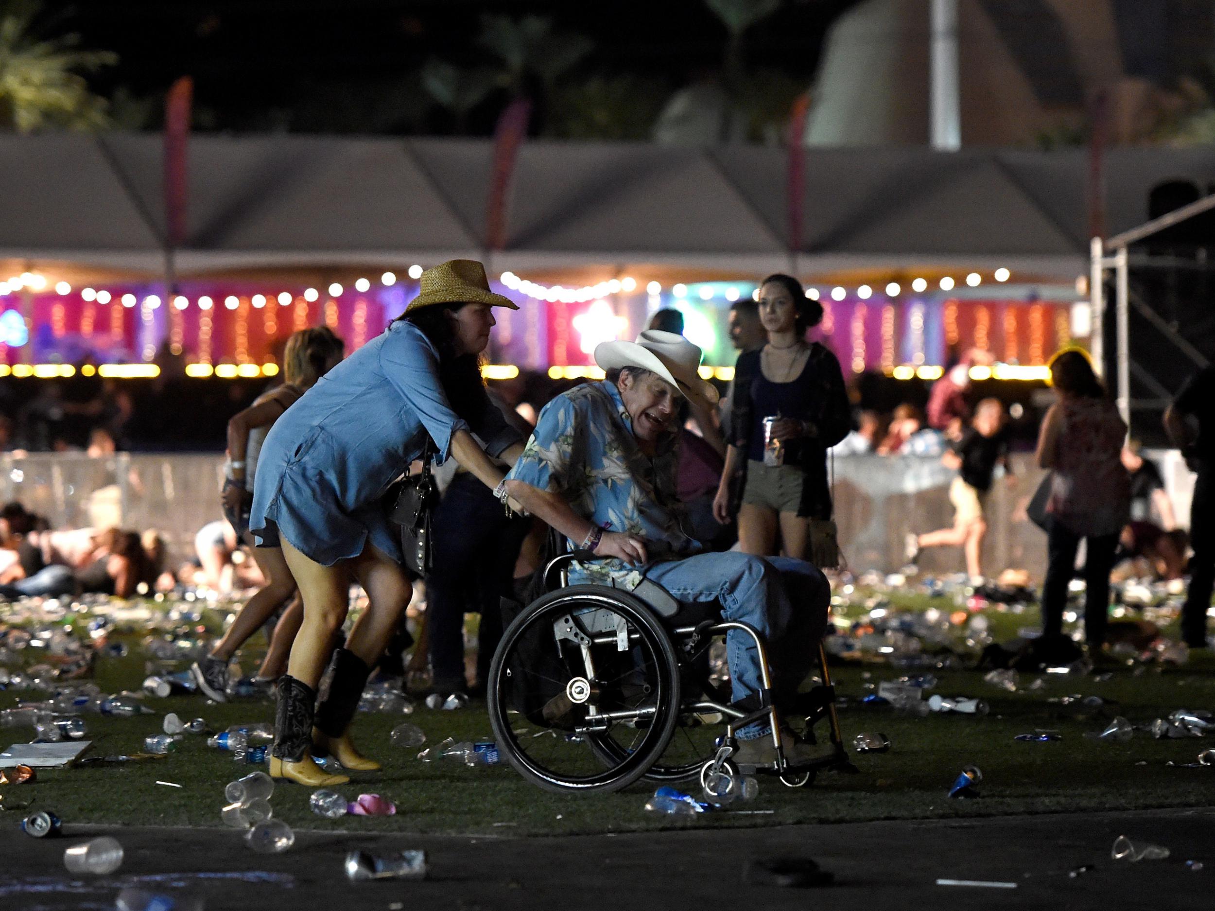 A man in a wheelchair is taken away from the festival after gun fire was heard