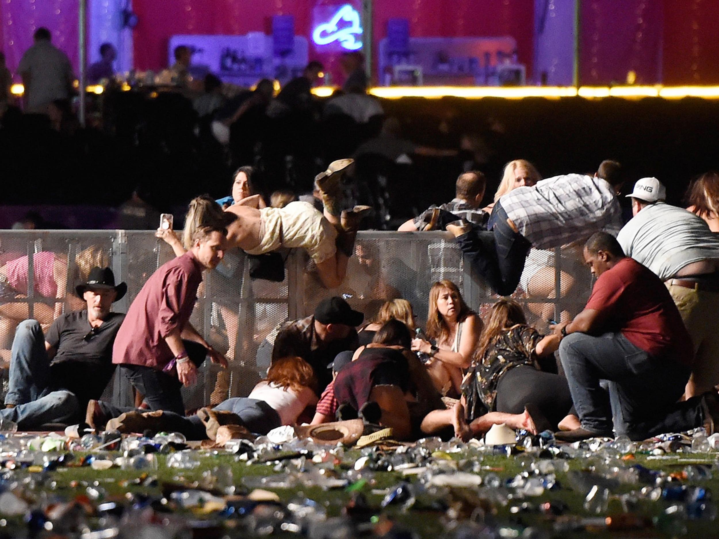 People scramble for shelter at the Route 91 Harvest country music festival after gun fire was heard (David Becker/Getty)