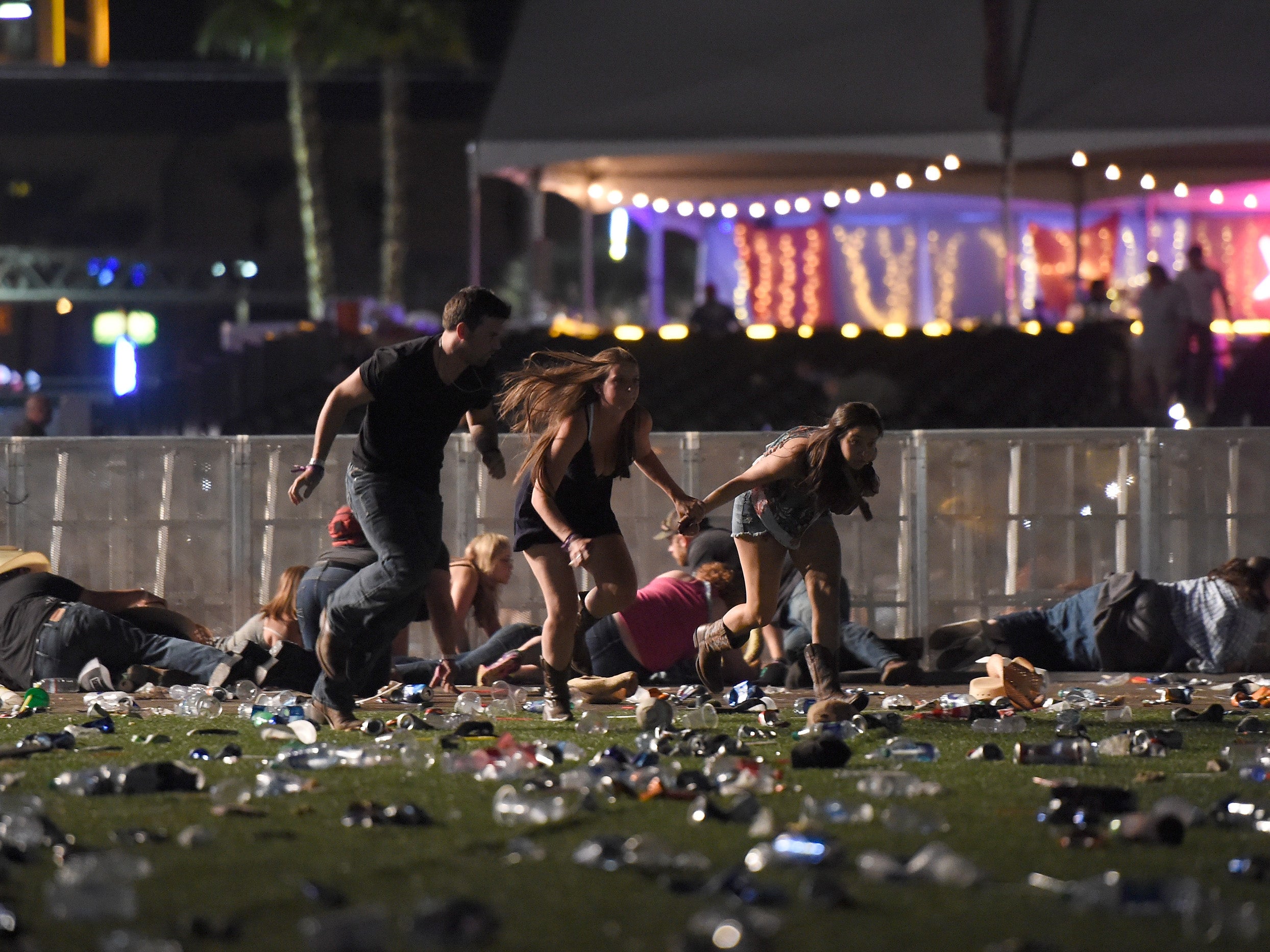 Music fans run for cover (David Becker/Getty)