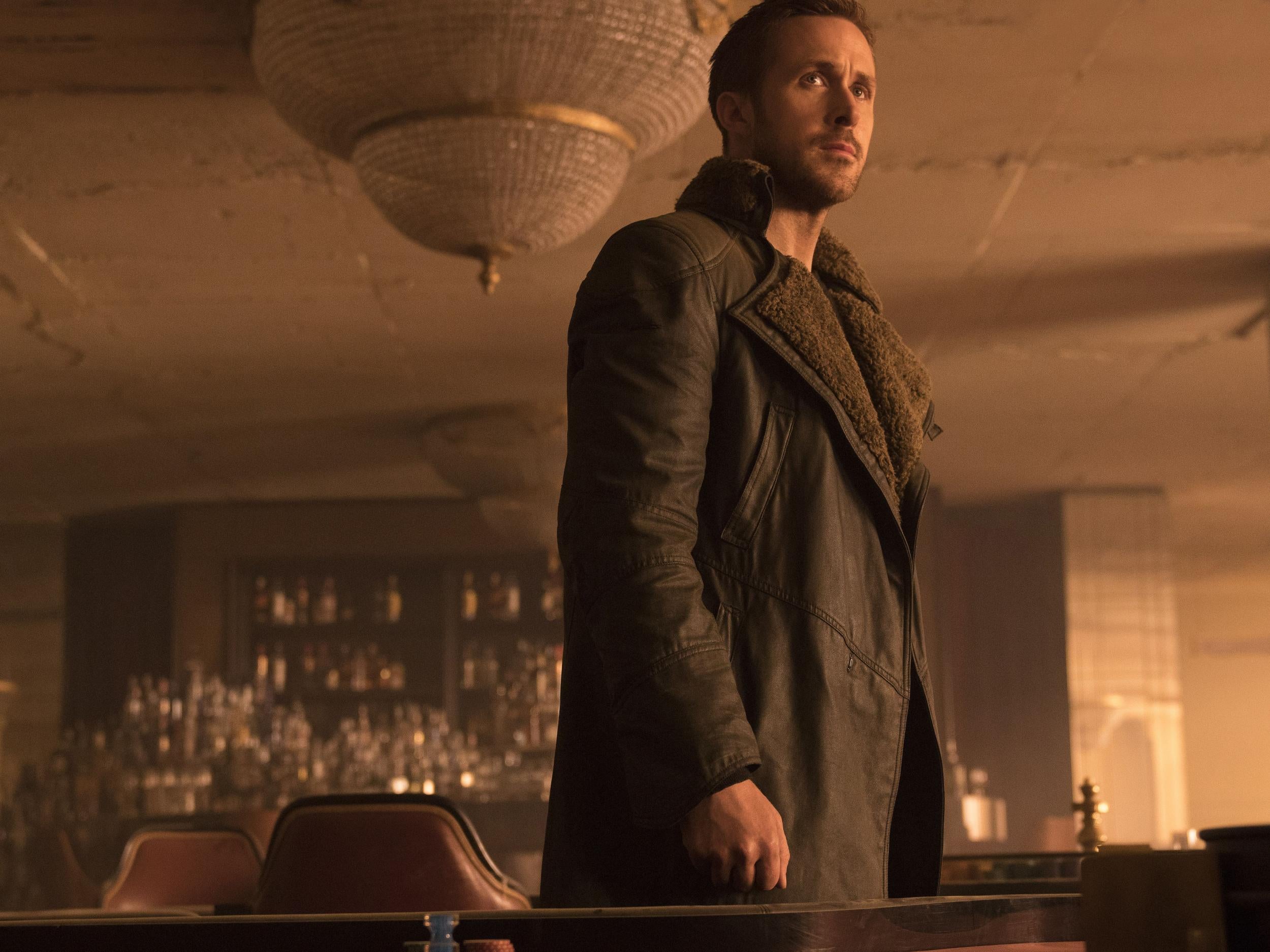 Ryan Gosling as Officer K in his ever-present coat