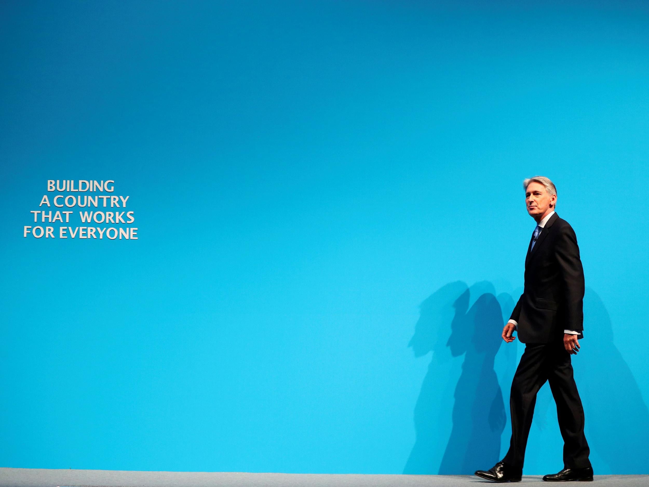 Britain's Chancellor of the Exchequer Philip Hammond arrives to speak at the Conservative Party's conference in Manchester