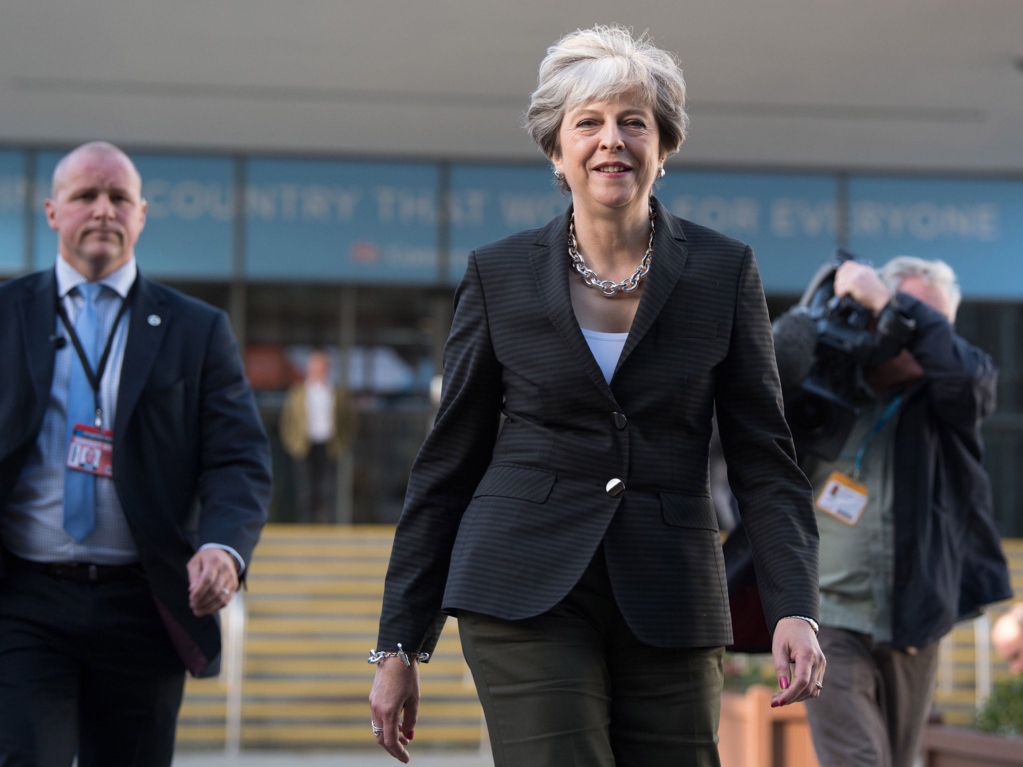 Theresa May walks to her hotel after conducting morning interviews on day three of the annual Conservative Party conference on October 3, 2017 in Manchester, England