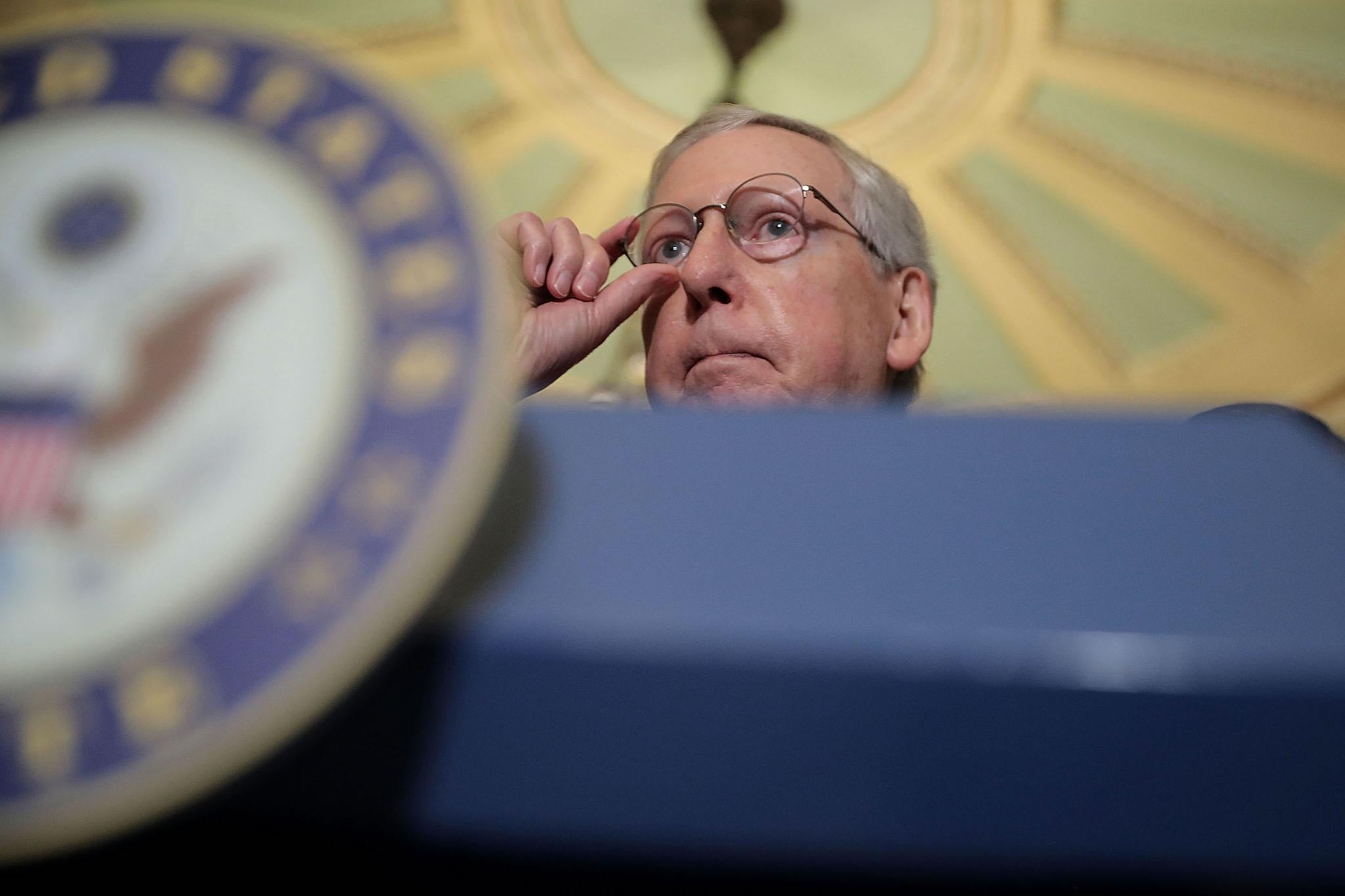 Senate Majority Leader Mitch McConnell talks to reporters