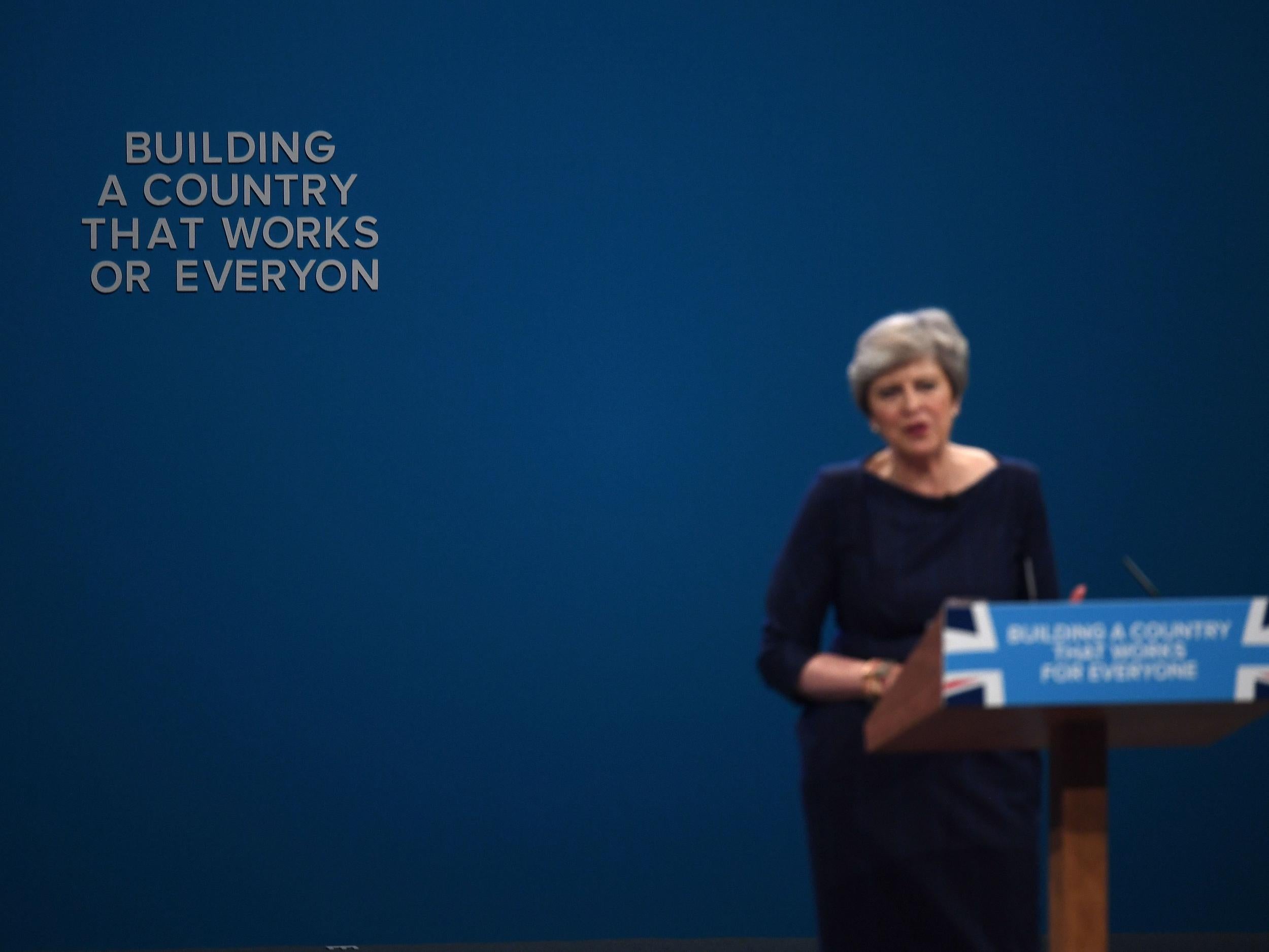 Confused message: letters fall off the backdrop as Theresa May speaks during a Tory conference