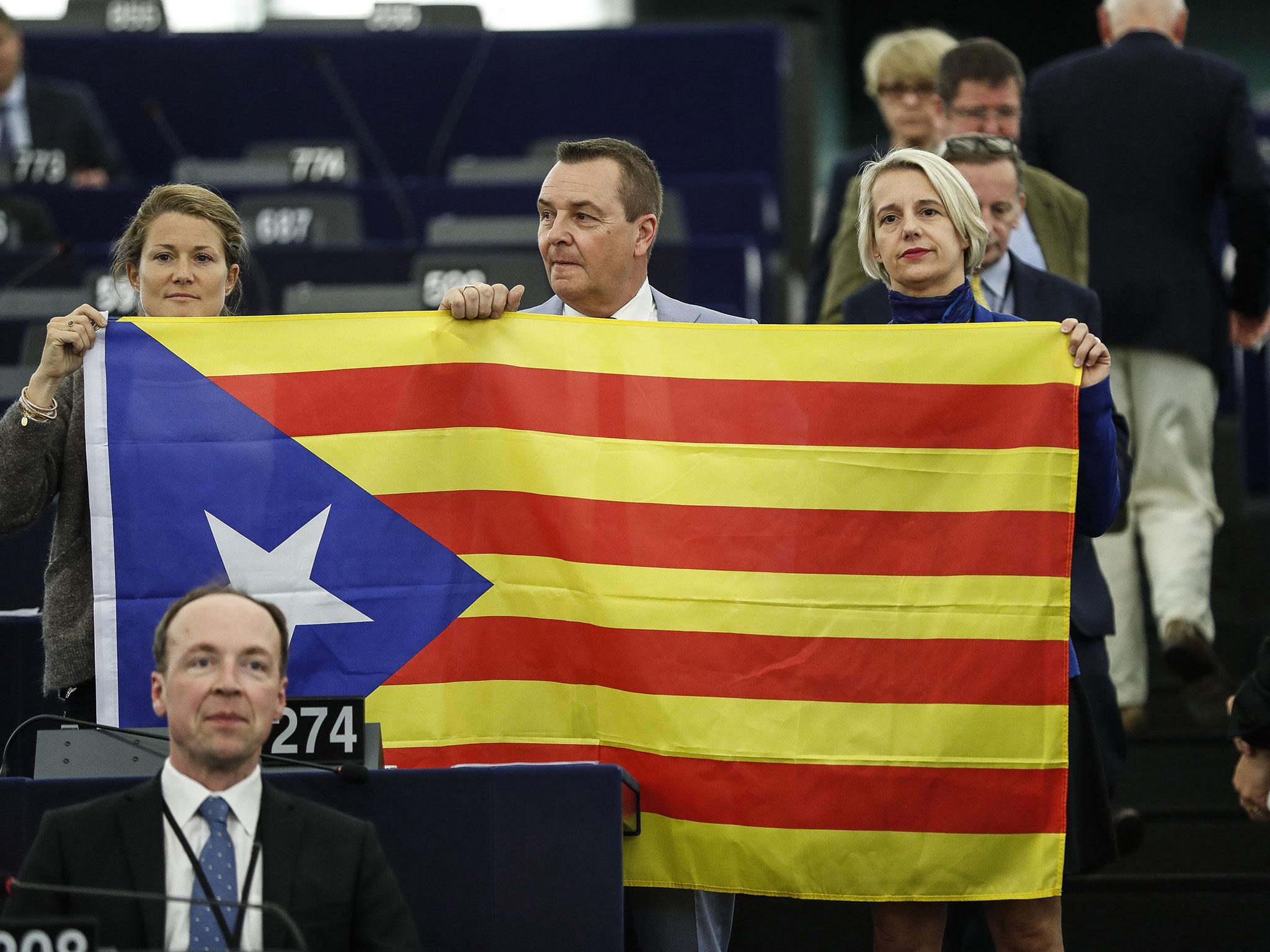 Belgium members of the European Parliament display a Catalan flag in support of the disputed independence movement during a session at the European Parliament on Wednesday