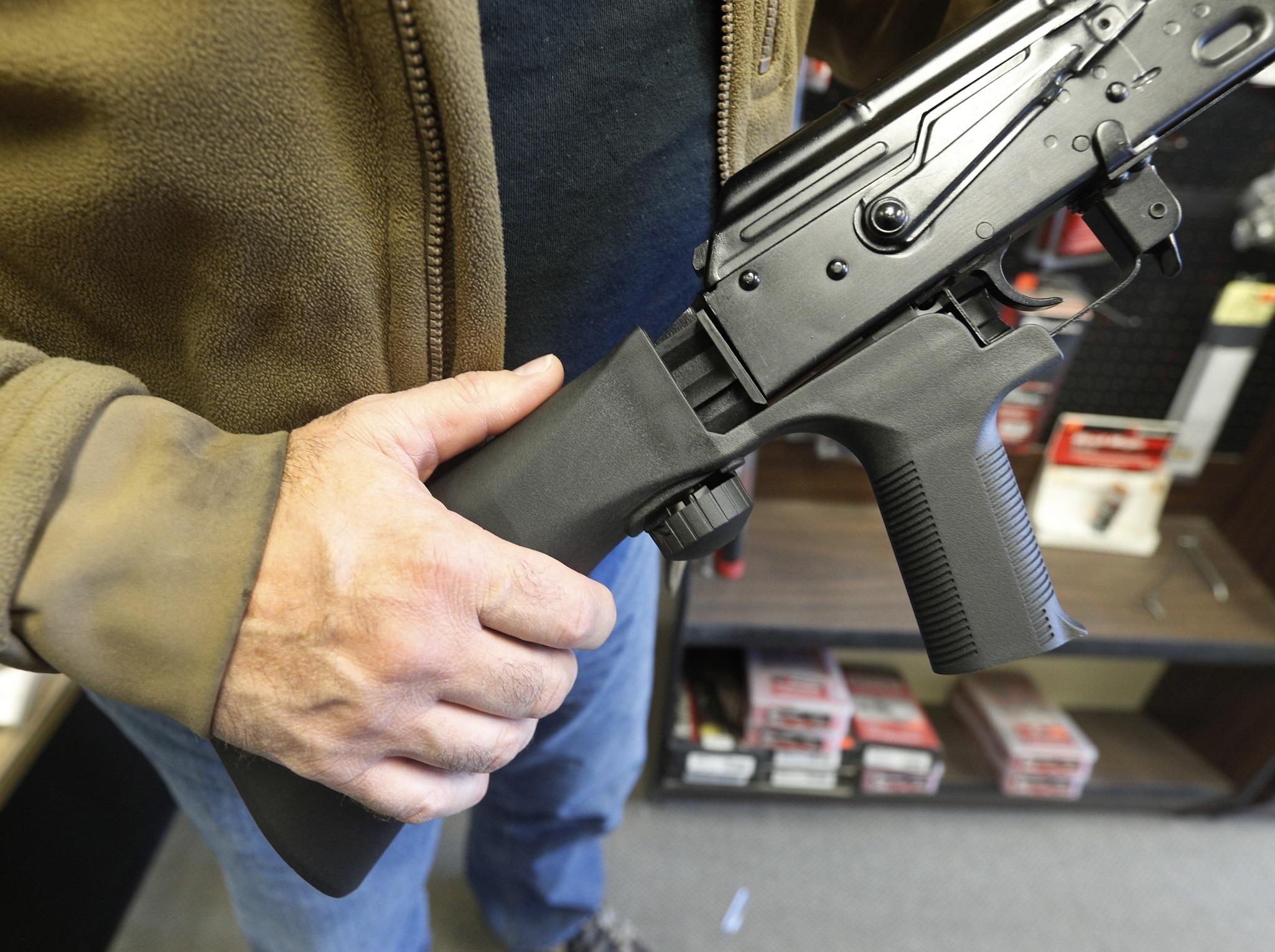 A bump stock is installed on a AK-47 semi-automatic rifle to increase its firing speed