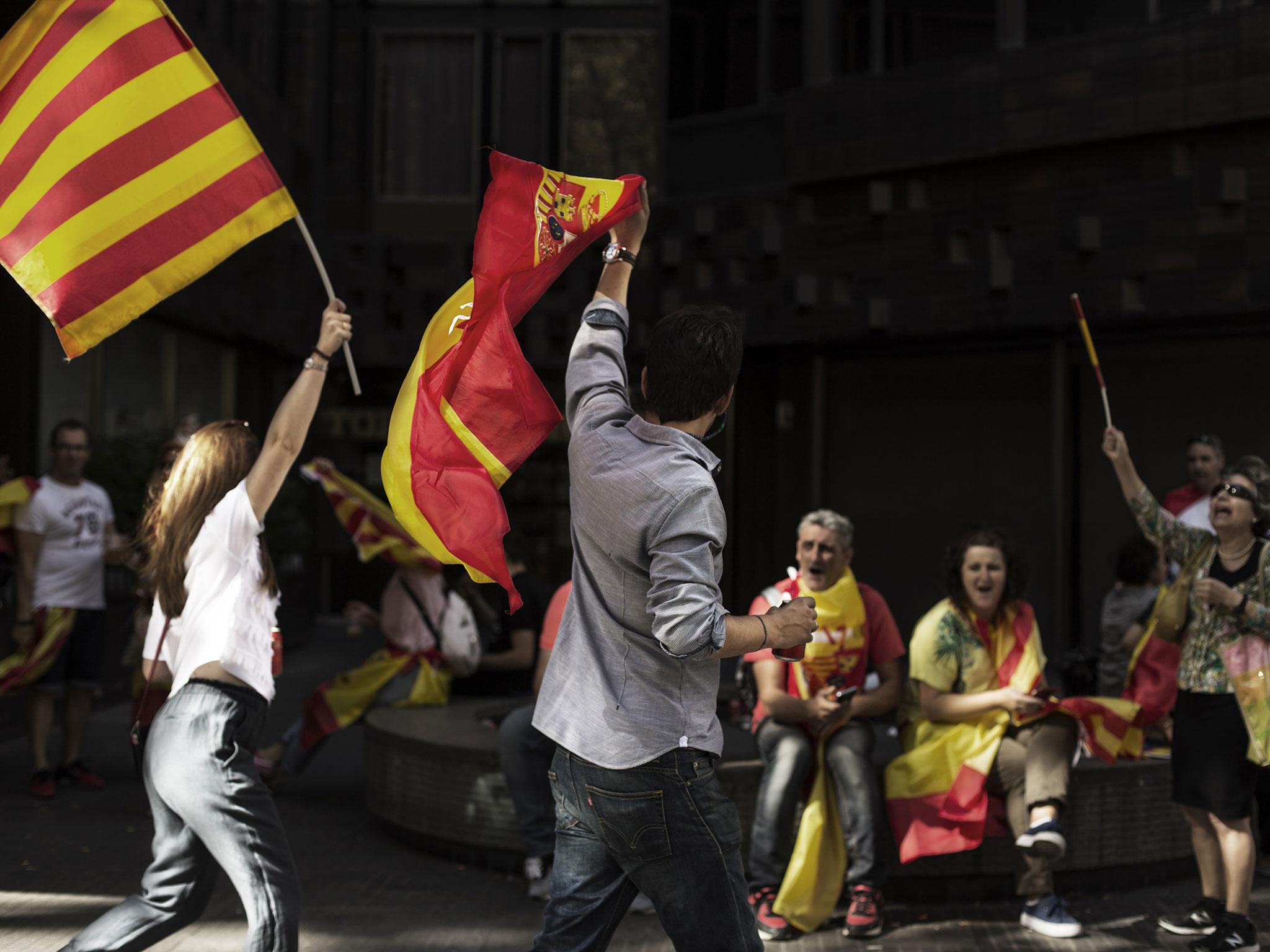 People make their way home following a Pro-Unity rally march through Barcelona