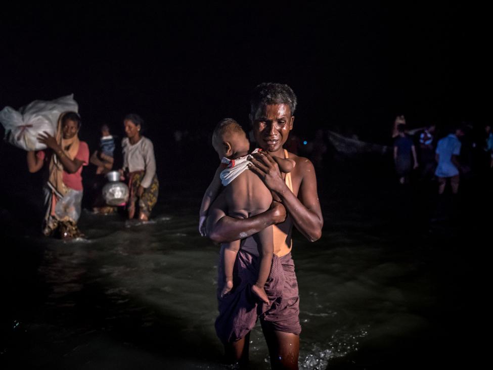 Rohingya refugees arriving in Bangladesh after crossing the Naf River this month