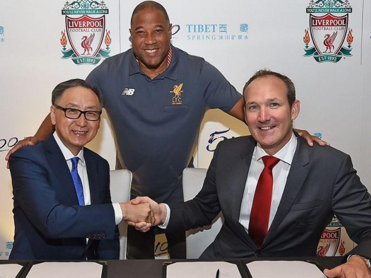 Liverpool legend John Barnes poses with the club's commercial director Billy Hogan and Tibet Water executive director Sunny Wong