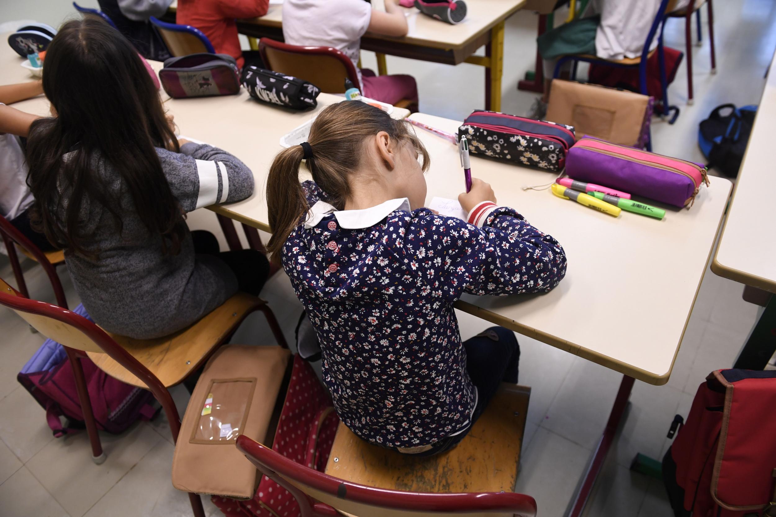 Children not involved in the case sit in school in a different school district