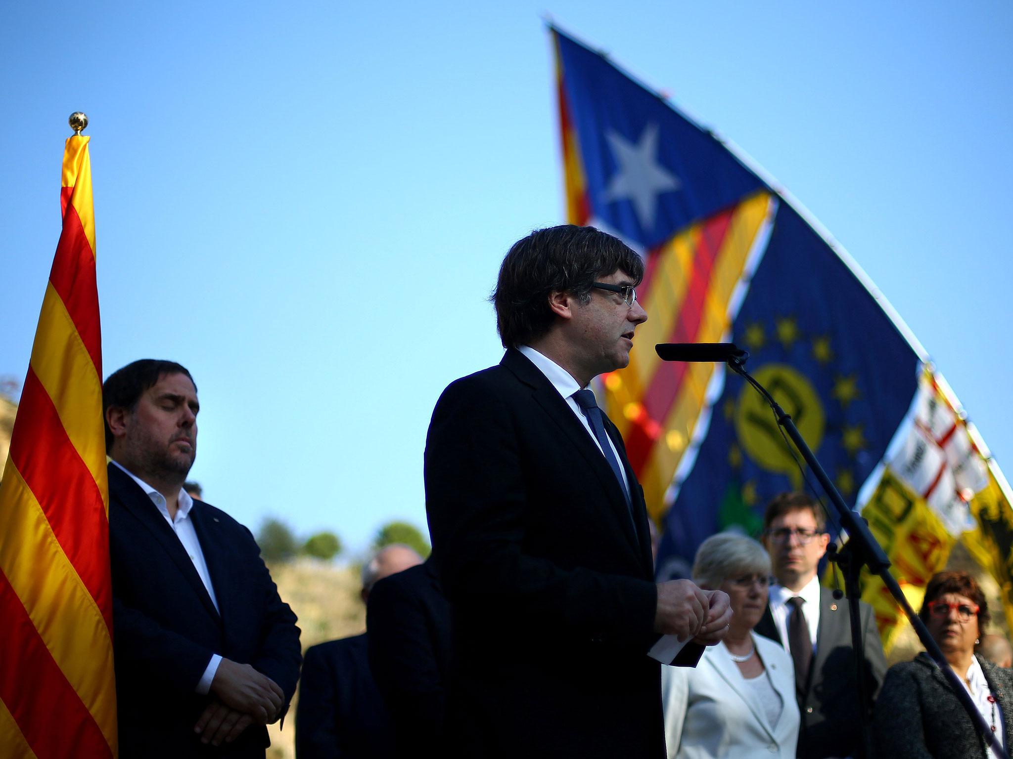 Catalan President Carles Puigdemont delivers a speech at the memorial of ‘Fossar de la Pedrera’ in Barcelona on Sunday