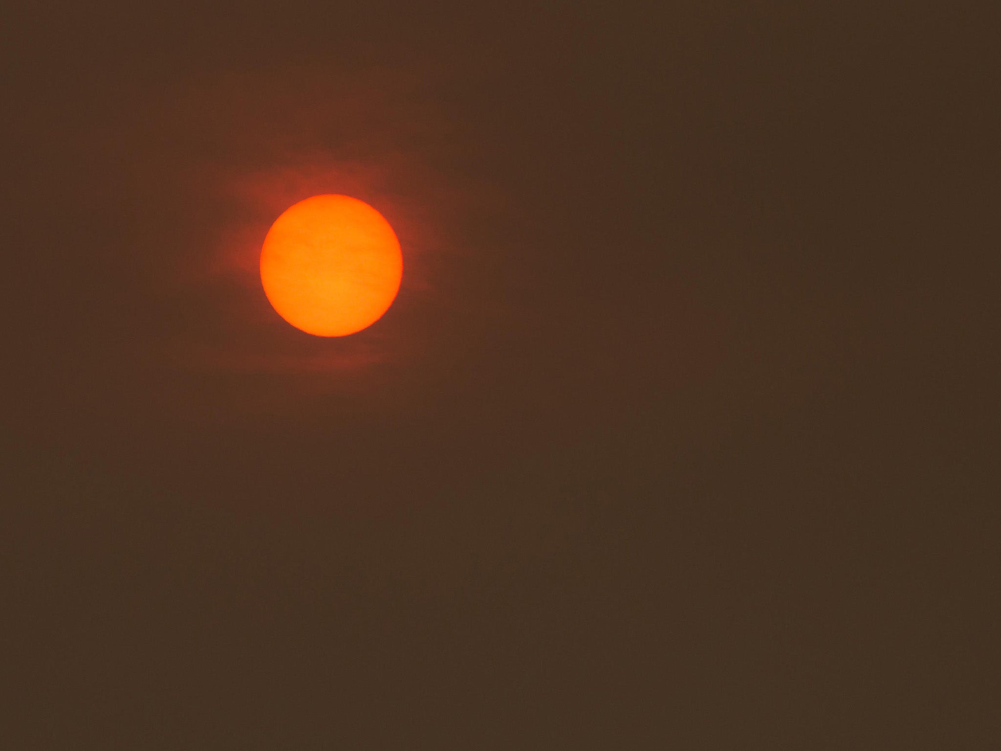 A Red Sun in the sky above Aberdovey on the Welsh Coast