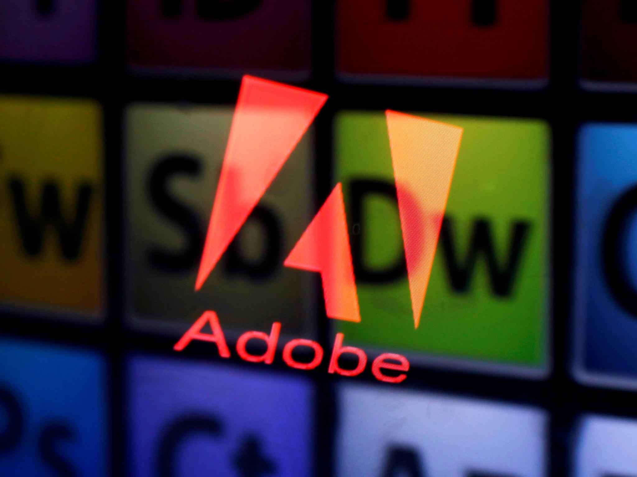 An Adobe logo and Adobe products are seen reflected on a monitor display and an iPad screen, in this picture illustration July 8, 2013